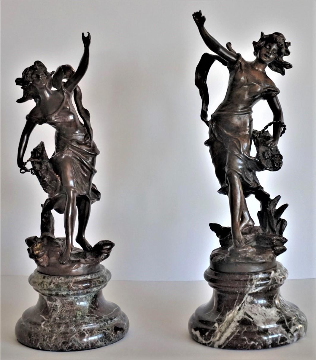 Set of two patinated bronze female figures on marble bases, allegory of freedom, dancing young women with a flower basket, France late 19th century, both sculptures signed Geo Maxim.

Measures: One sculpture is 15 inches high, 5.50 inches diameter