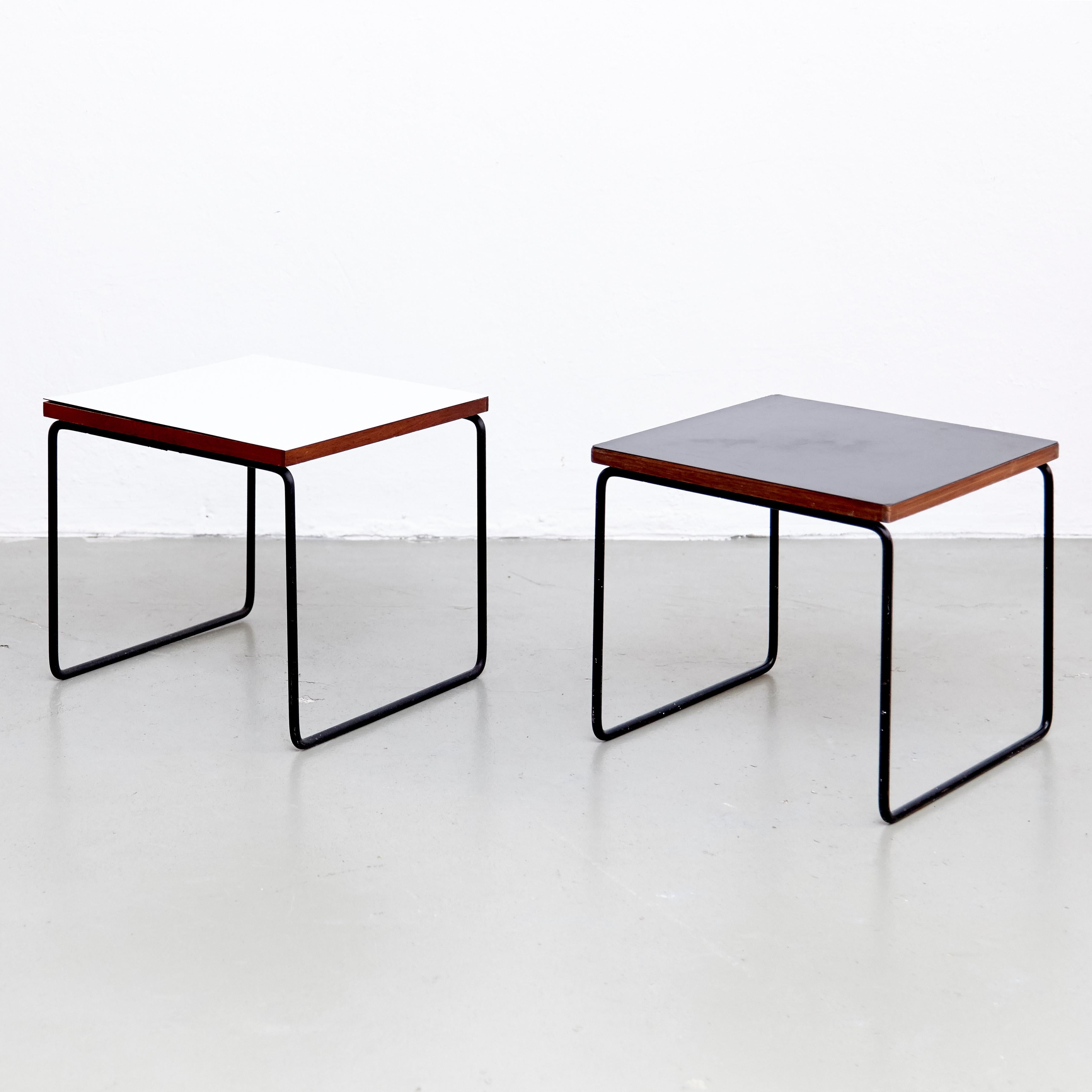 Set of two side tables designed by Pierre Guariche.
Manufactured by Steiner (France), circa 1950.
Bent and painted iron frame, laminated wood.

One table not signed. One table signed with applied manufacturer's label to underside: