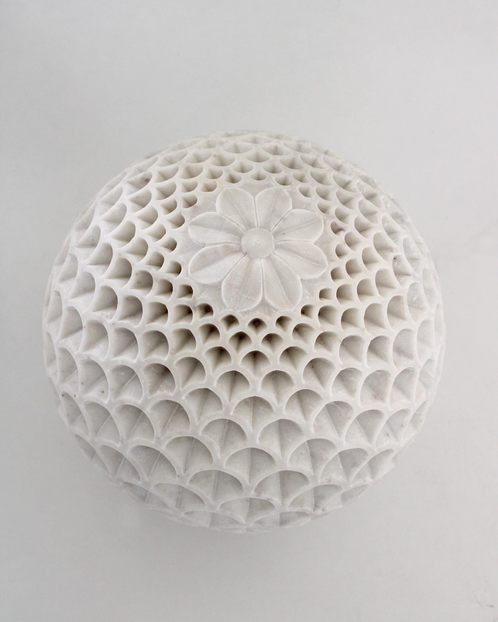 Inspired by the Pinecone, Paul Mathieu designed this beautiful floor/outdoor lighting fixture. Solid pieces of marble are first turned into hemispherical halves and hand-carved to create the intricate carving motif which plays with the translucent