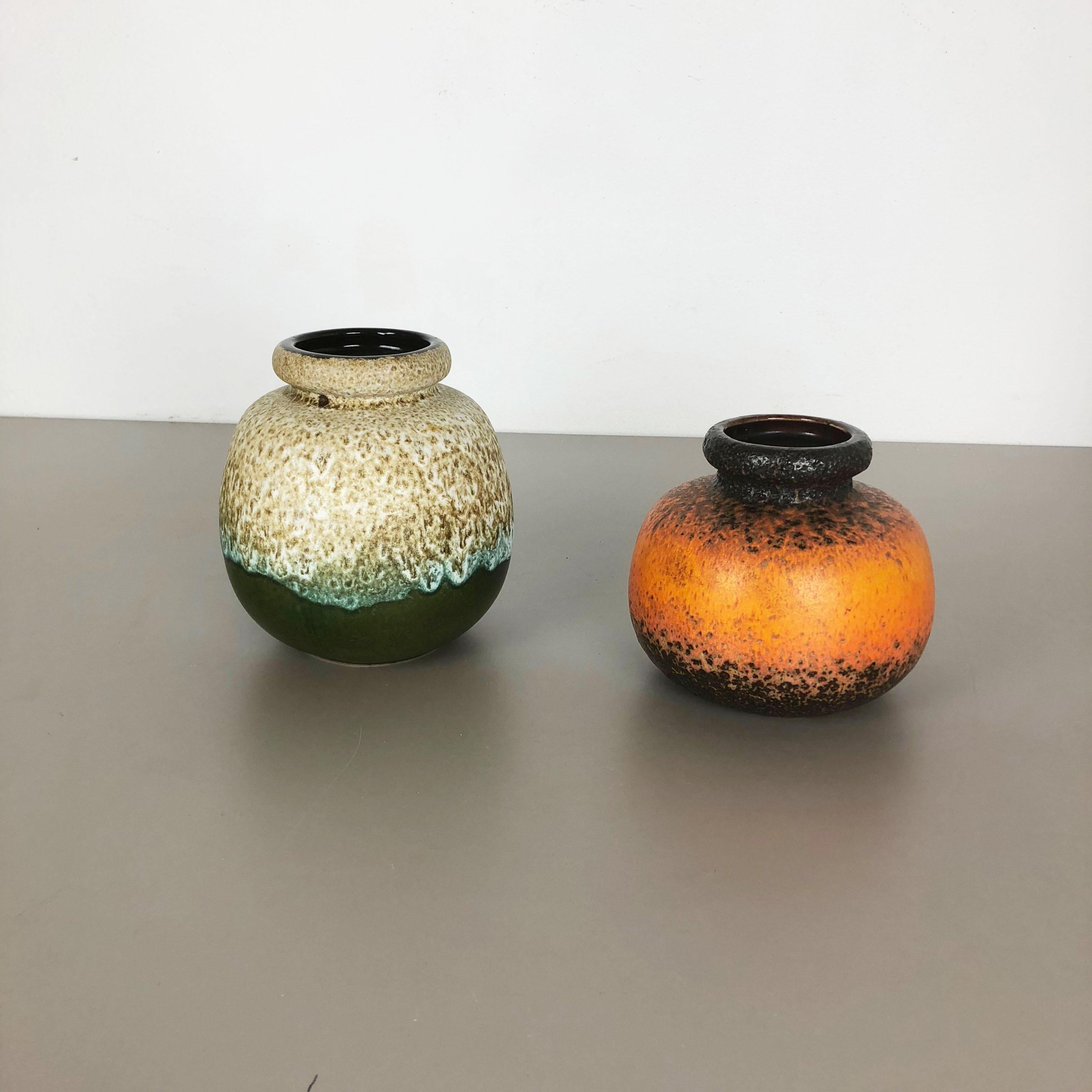 Article:

Set of two fat lava art vases

Model:
284-15
284-19



Producer:

Scheurich, Germany



Decade:

1970s




These original vintage vases was produced in the 1970s in Germany. It is made of ceramic pottery in fat lava