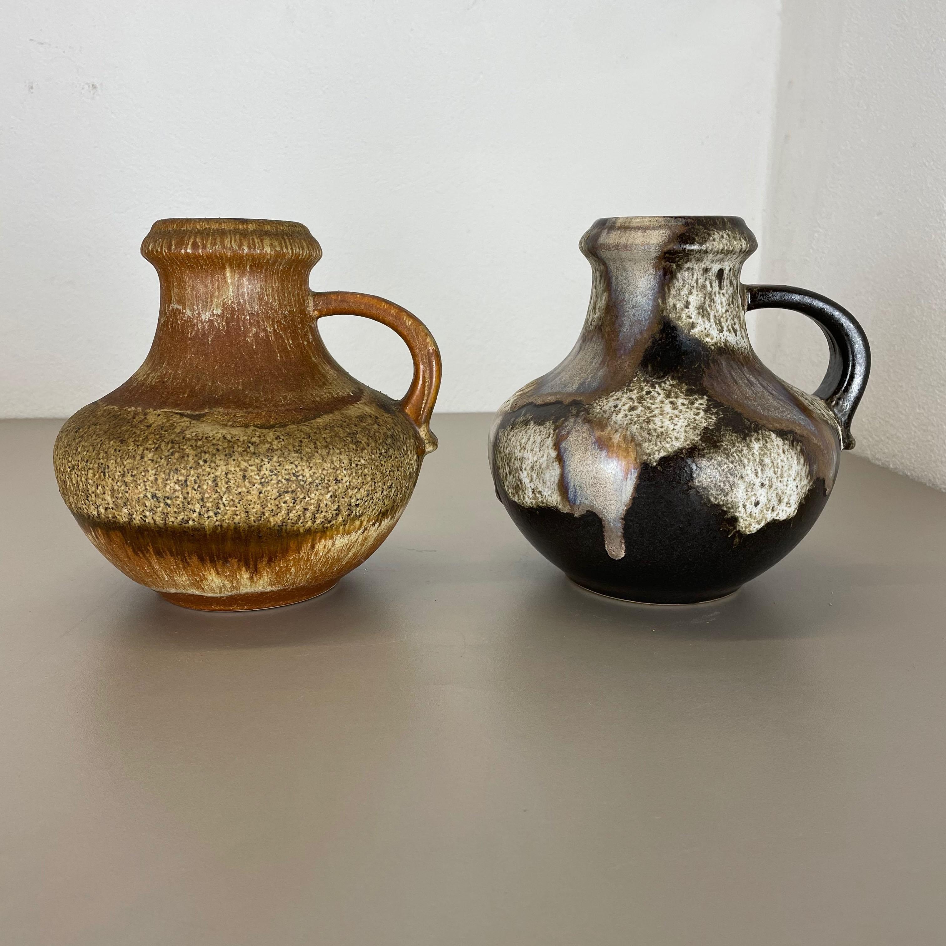 Article:

Set of two fat lava art vases


Producer:

Scheurich, Germany



Decade:

1970s




These original vintage vases was produced in the 1970s in Germany. It is made of ceramic pottery in fat lava optic. Super rare in this