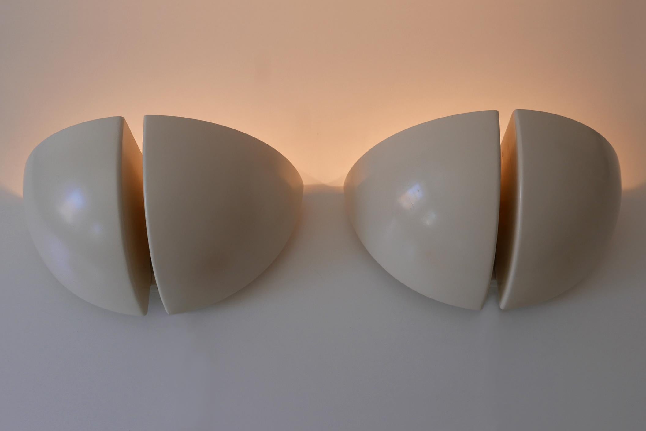 Set of two award winning minimalistic and elegant Mid-Century Modern Oktavo two-flamed wall lamps or sconces. Model C-1542. Designed and manufactured by RAAK, Netherlands, 1970s.

The Oktavo wall lamp which can be mounted up or downwards, won 1980