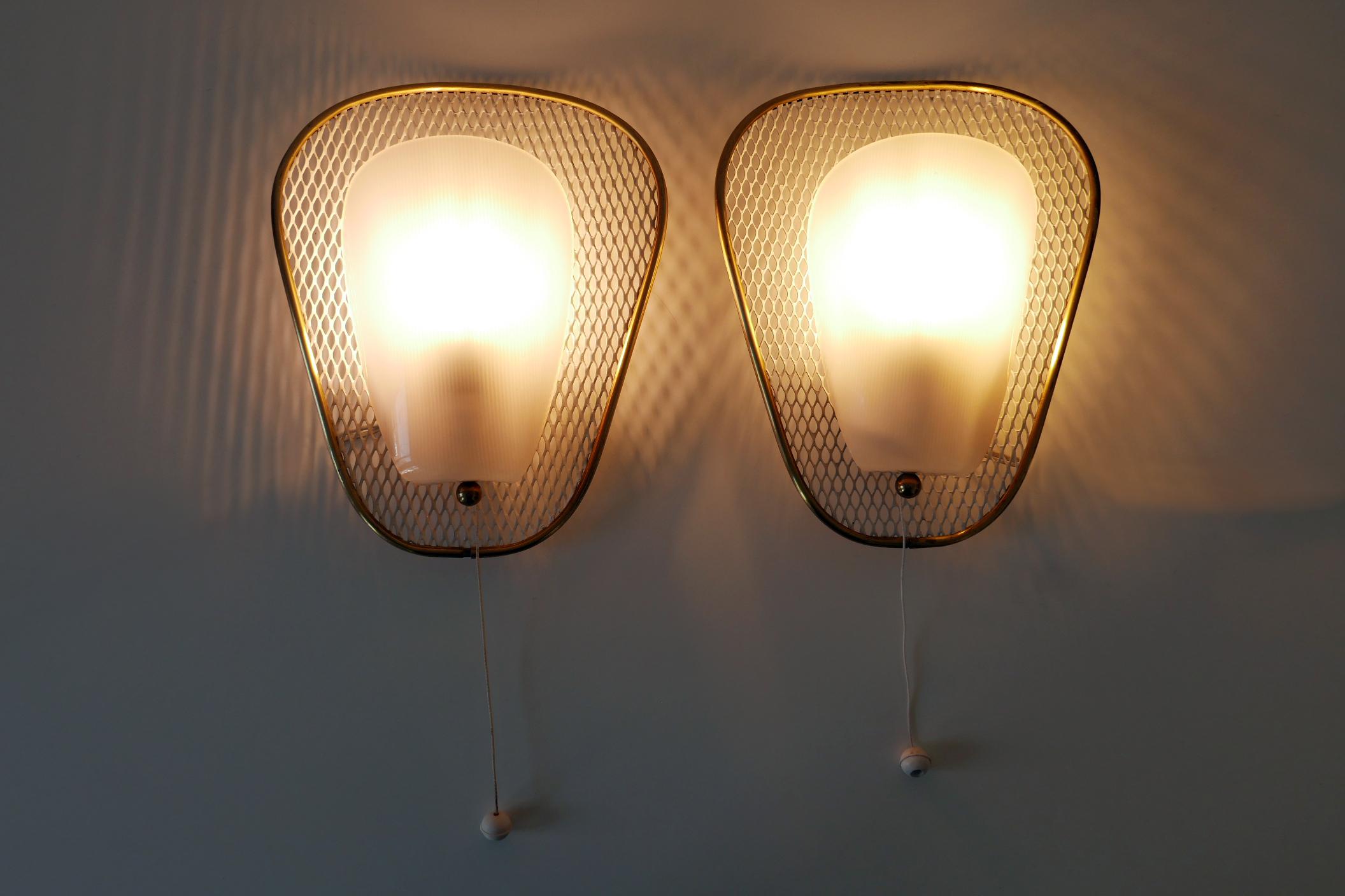Set of two rare, elegant and highly decorative Mid-Century Modern sconces or wall fixtures. Designed & manufactured in Germany, 1950s.

Executed in brass, metal and plastic, each sconce is executed with 1 x E14 / E12 Edison screw fit bulb socket, is