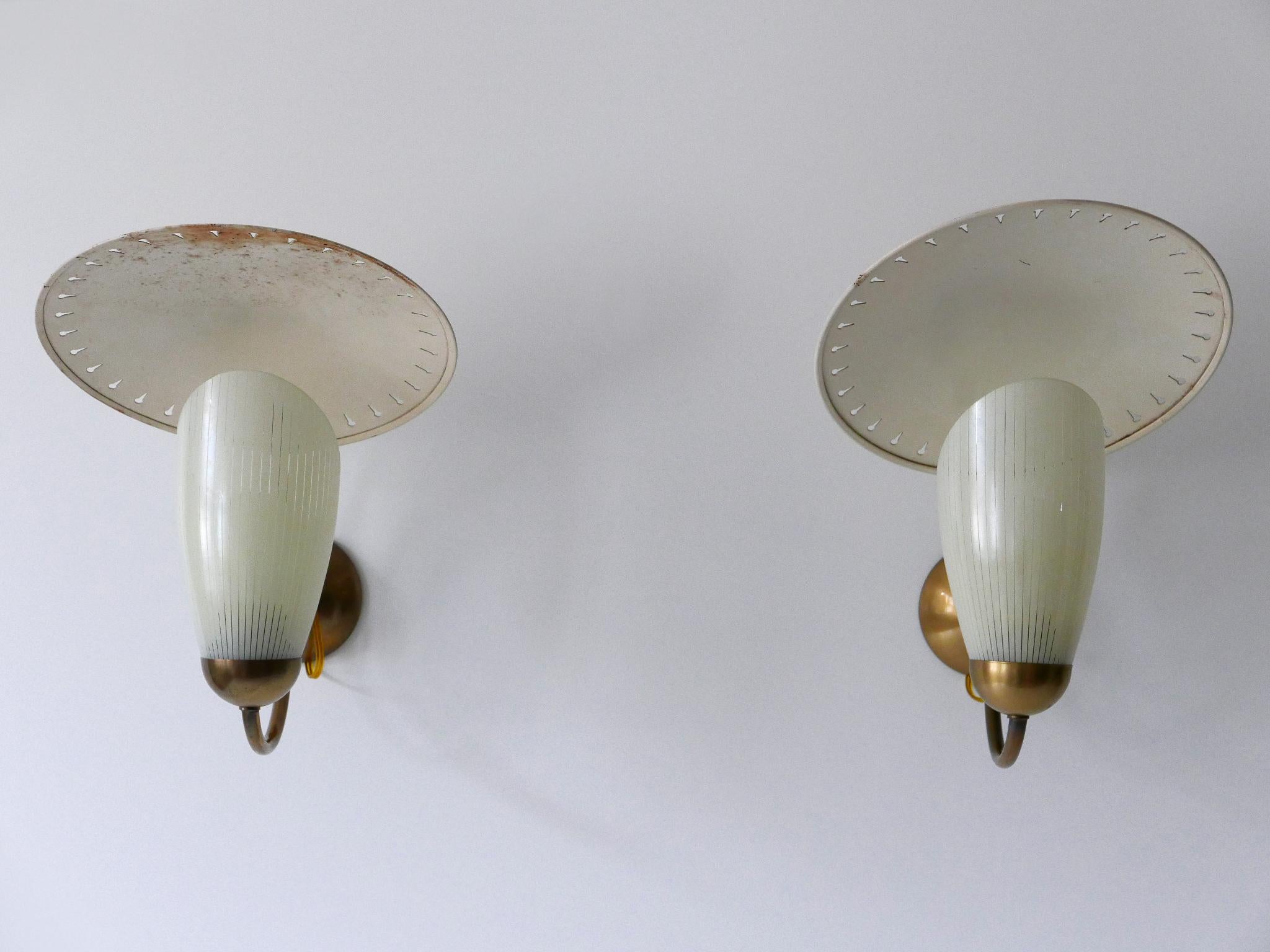 Set of two extremely rare and highly decorative Mid-Century Modern sputnik sconces or wall lights. Designed and manufactured in Germany, 1950s.

Executed in enameled metal and brass; each sconce needs 1 x E27 / E26 Edison screw fit bulb. The