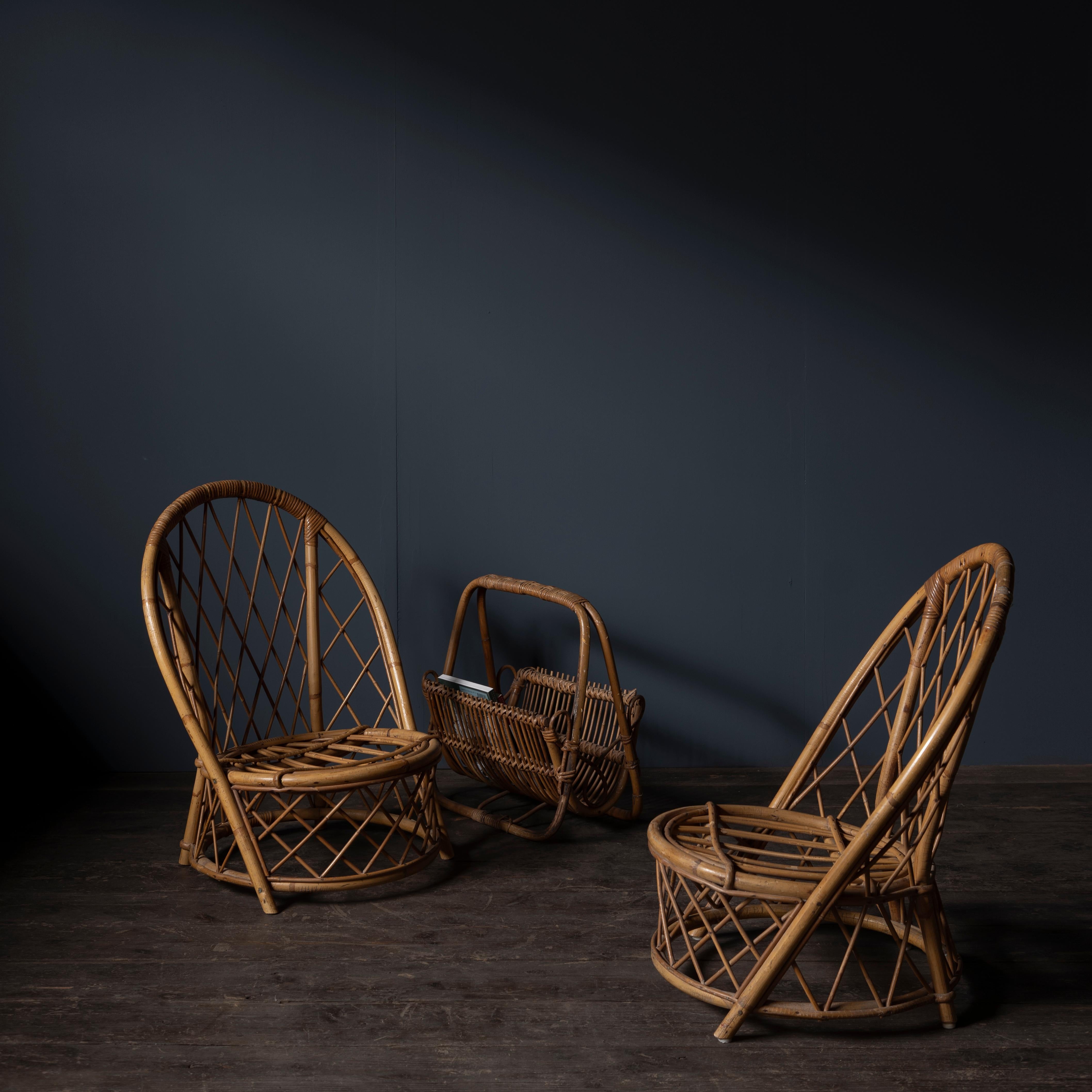 A set of two rattan low chairs and a magazine rack designed by French designers duo Adrien Audoux and Frida Minet.
1960s.
Original metal plates on the bottom of the chairs.

Dimensions
Chair: W45 x D51 x H70 x SH24.5 cm
Magazine rack: W46 x