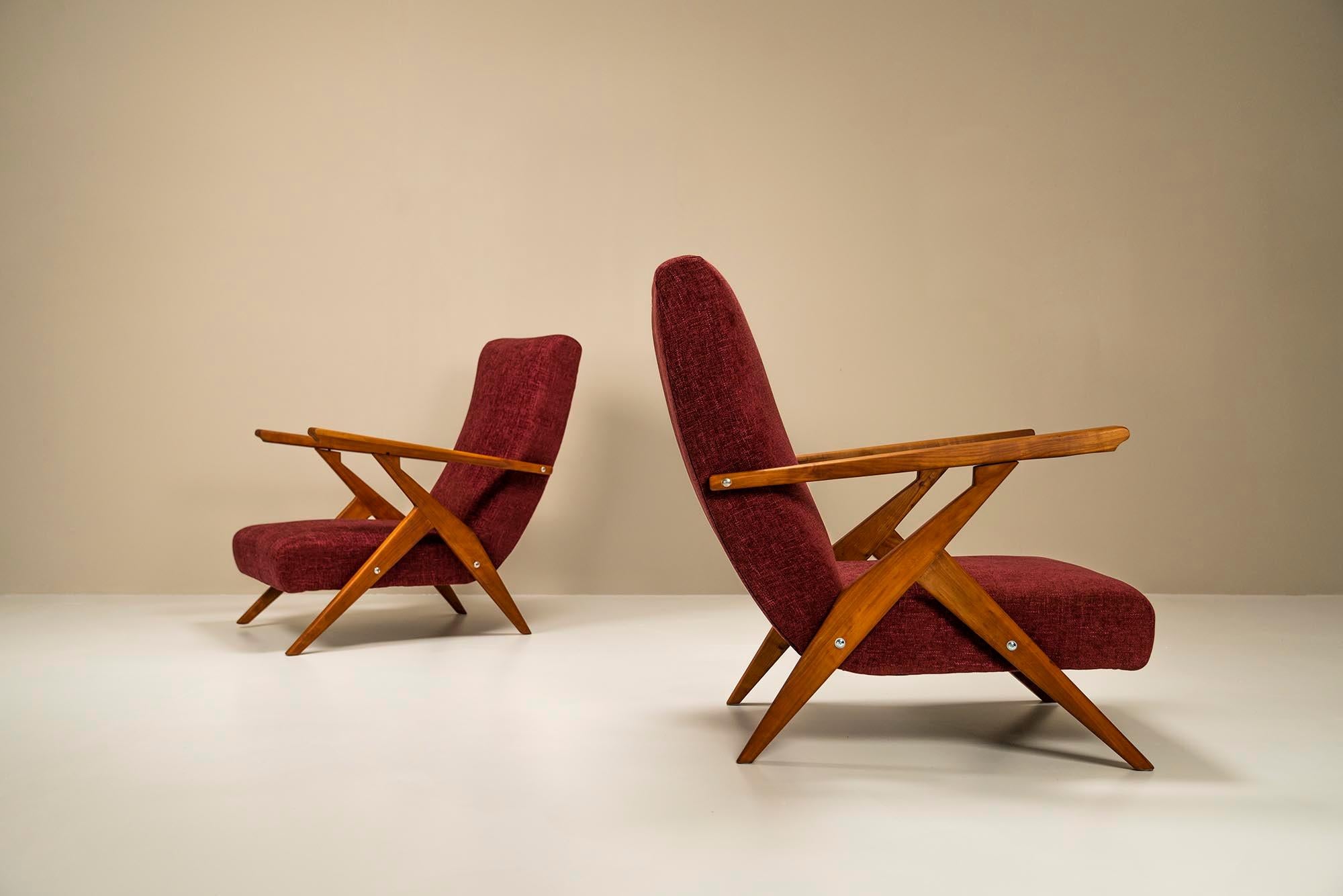 This set of Italian 1950s chairs is generous in size and will not fail to claim a prominent role, regardless of the interior in which they are placed. The very expressive frames of cherry wood are very sharply stylized. Its design strongly reminds