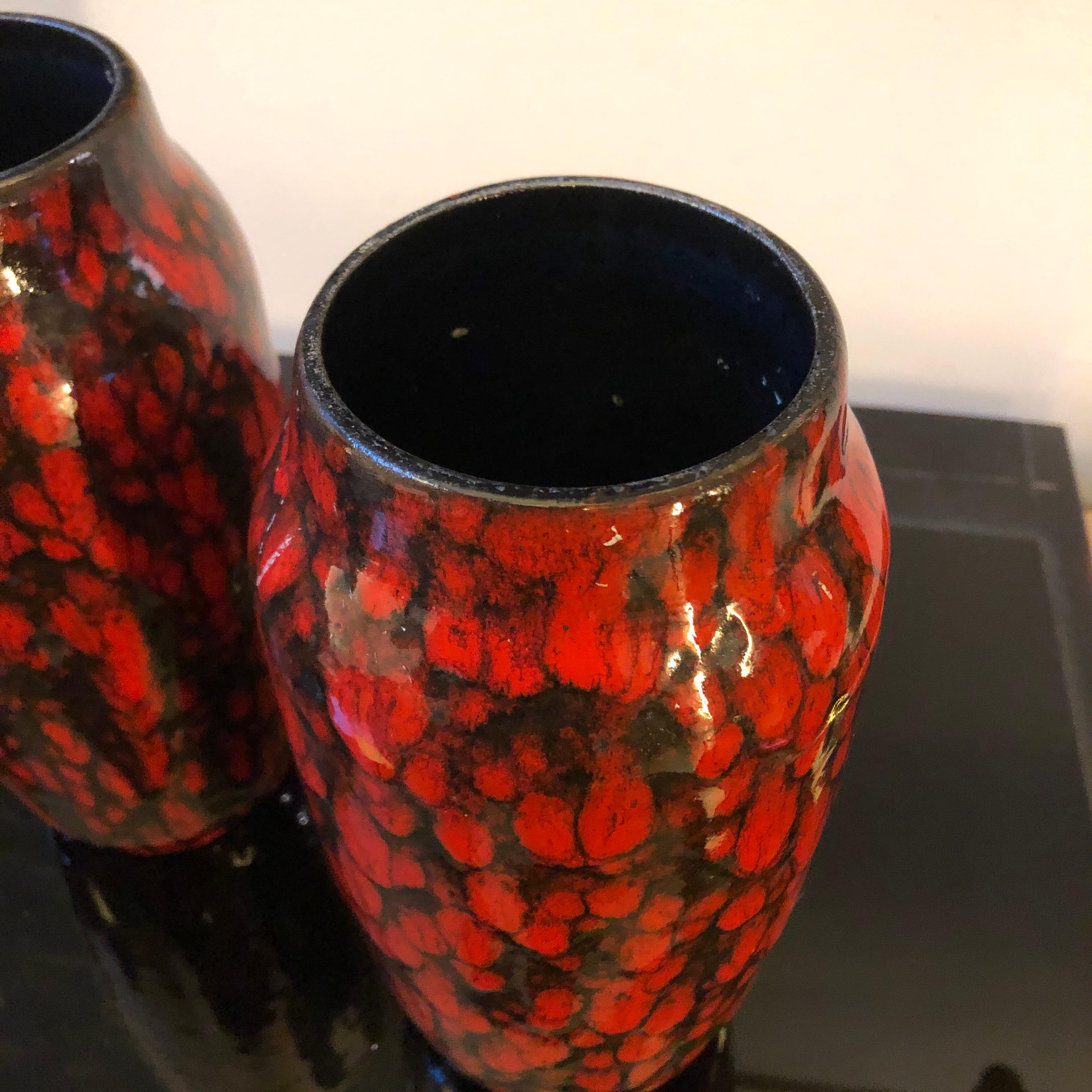 A pair of red and black ceramic vases made in Germany in the 1970s. Marked West Germany on the base.