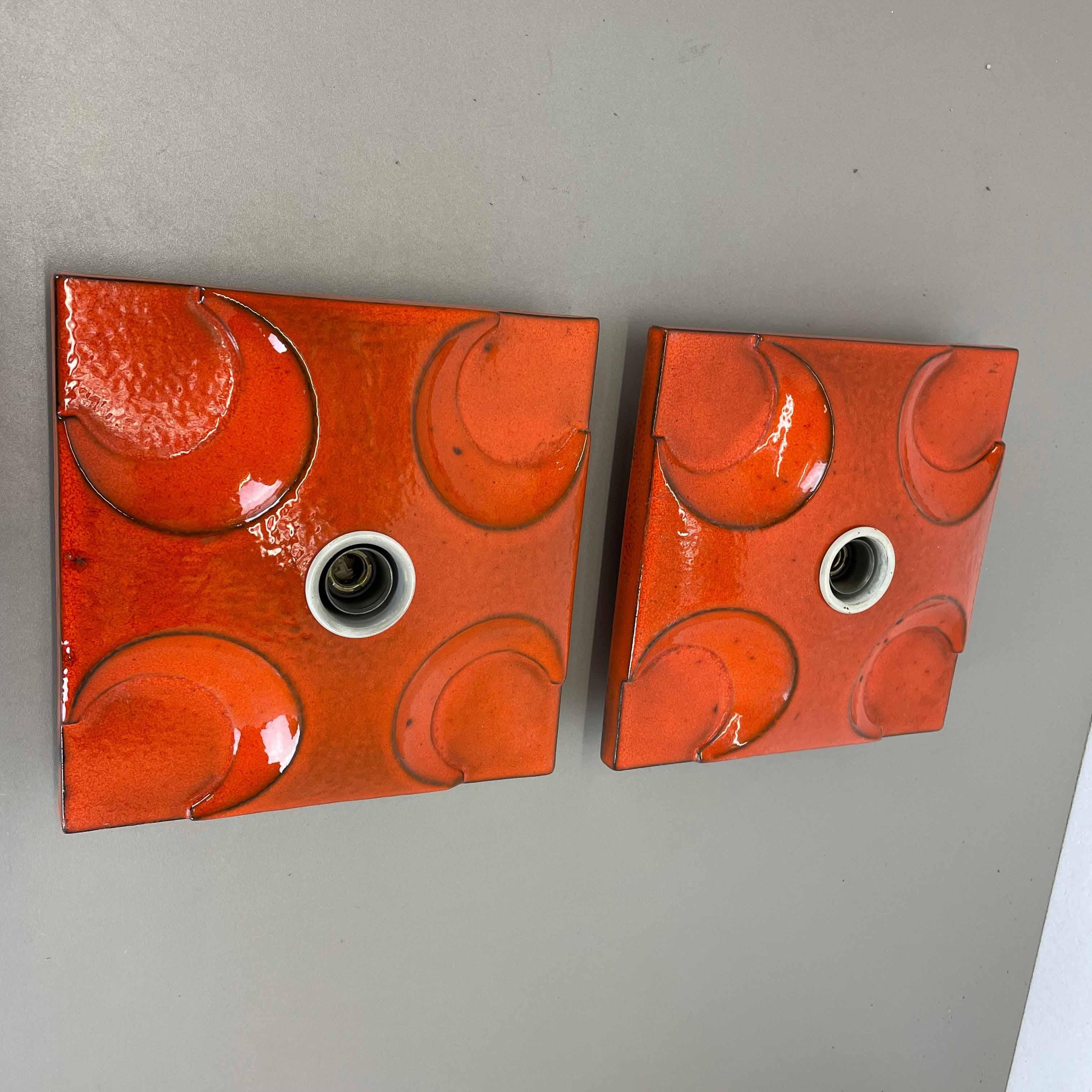 Article:

Wall light sconce set of two.


Producer:

Pan Ceramic, Germany.



Origin:

Germany.



Age:

1970s.



Description:

Original 1970s modernist German wall light made of ceramic in fat lava optic. This super rare