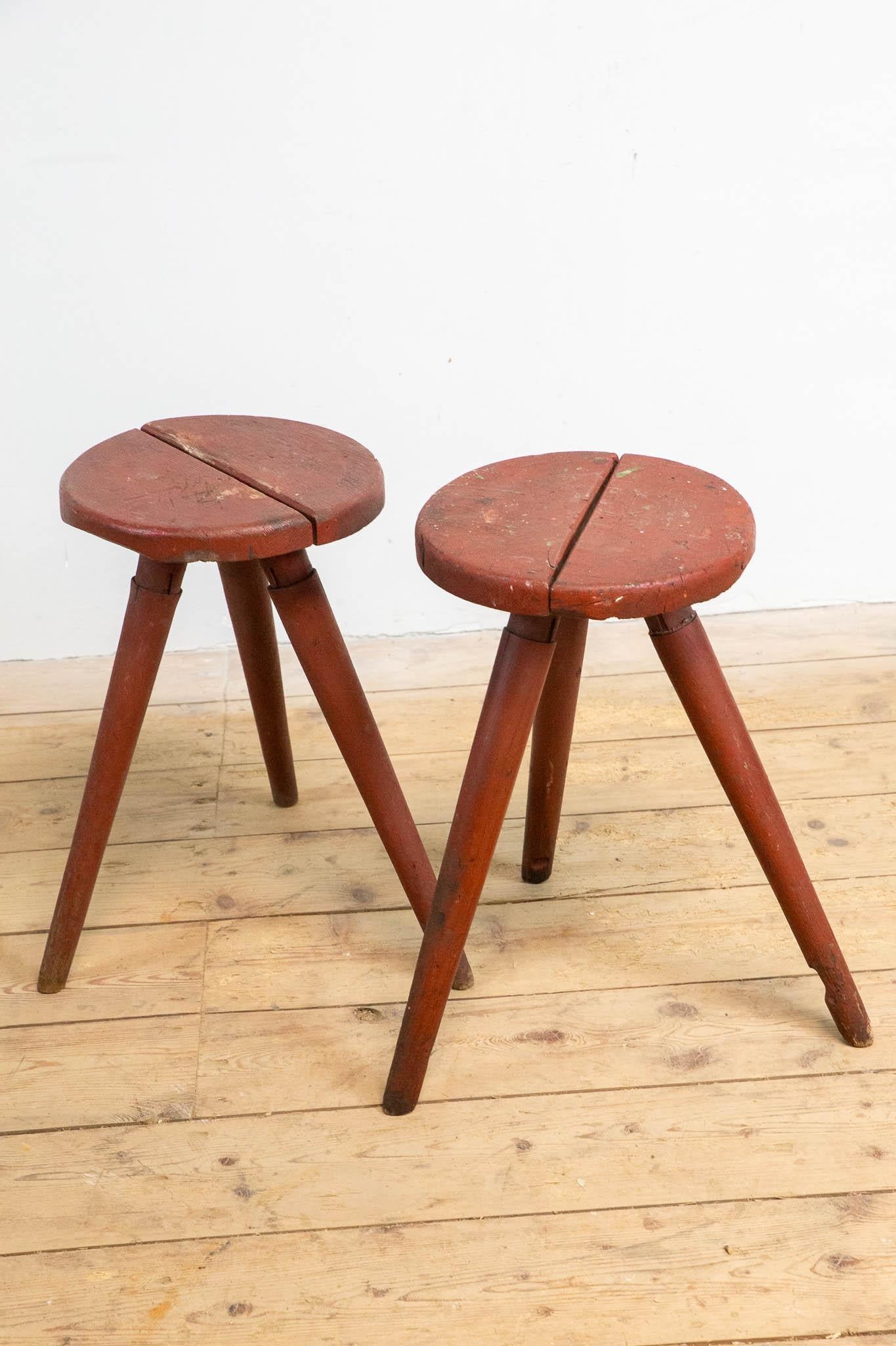 These charming German wooden stools exude simplicity and craftsmanship. With their distinctive three-legged design and warm reddish-brown patina, they bring an authentic, rustic atmosphere to any interior. The visible signs of use tell their own