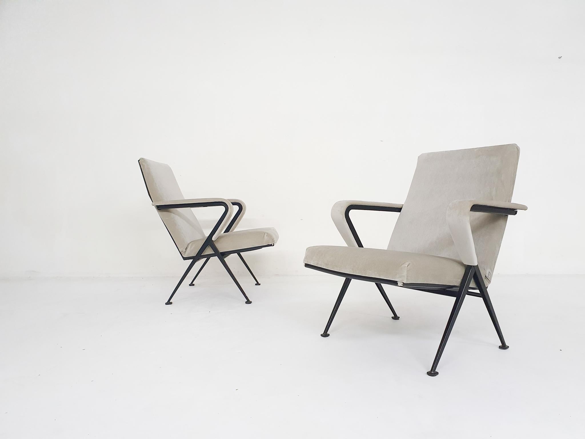 Black metal lounge chairs with new beige velvet upholstery. Designed by the Dutch Designer Friso Kramer for Ahrend de Cirkel in 1959.
The frame has some signs of use like scratches.

Friso Kramer
Kramer is the son of architect Piet Kramer. In 1963