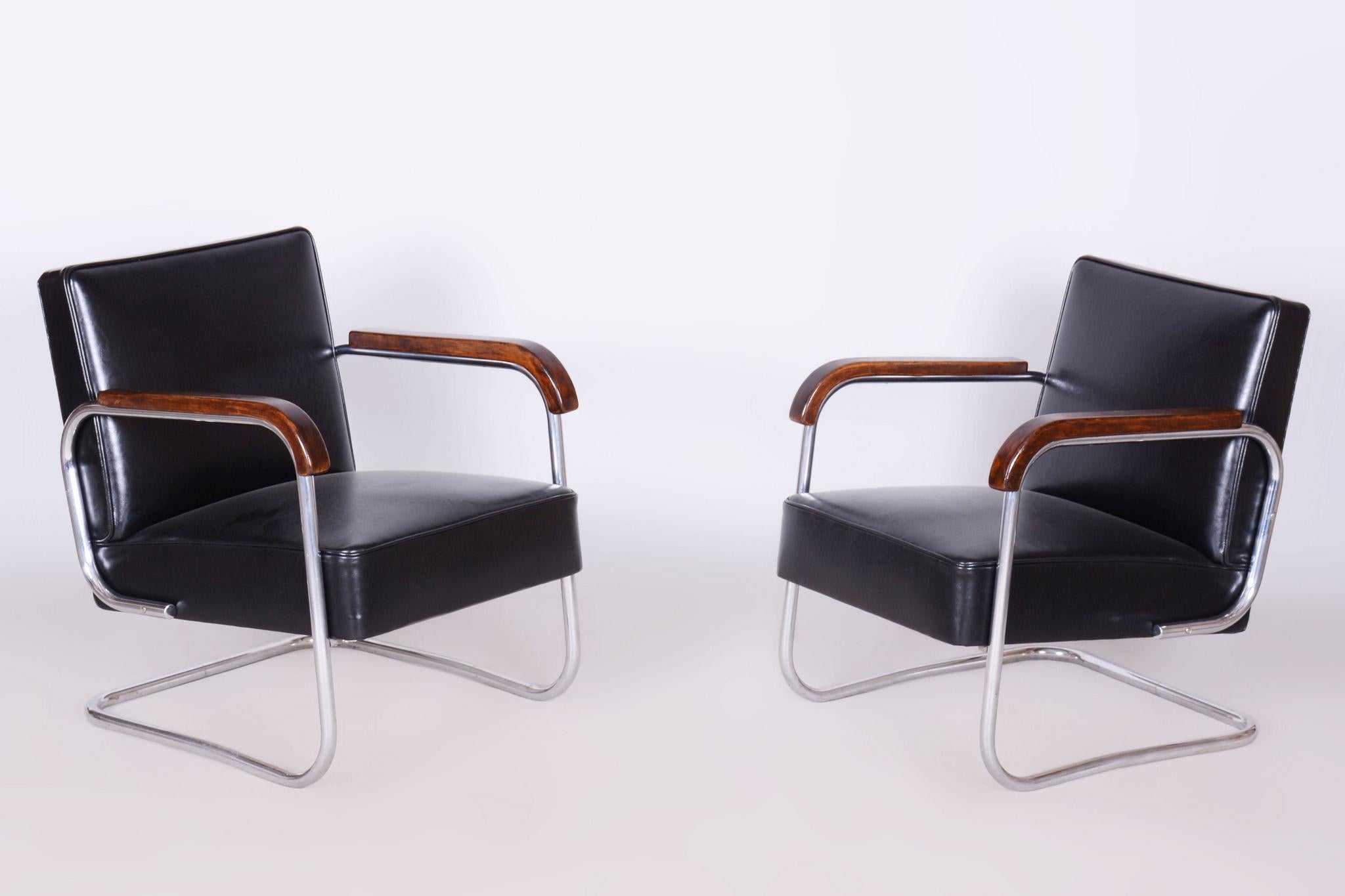 Restored Bauhaus Pair of Armchairs.

Source: Czechia (Czehoslovakia)
Period: 1930-1939
Material: Chrome-plated Steel, Cowhide, Beech

It has been re-polished with polyutherane piano lacquer by our professional refurbishing team in Czechia according