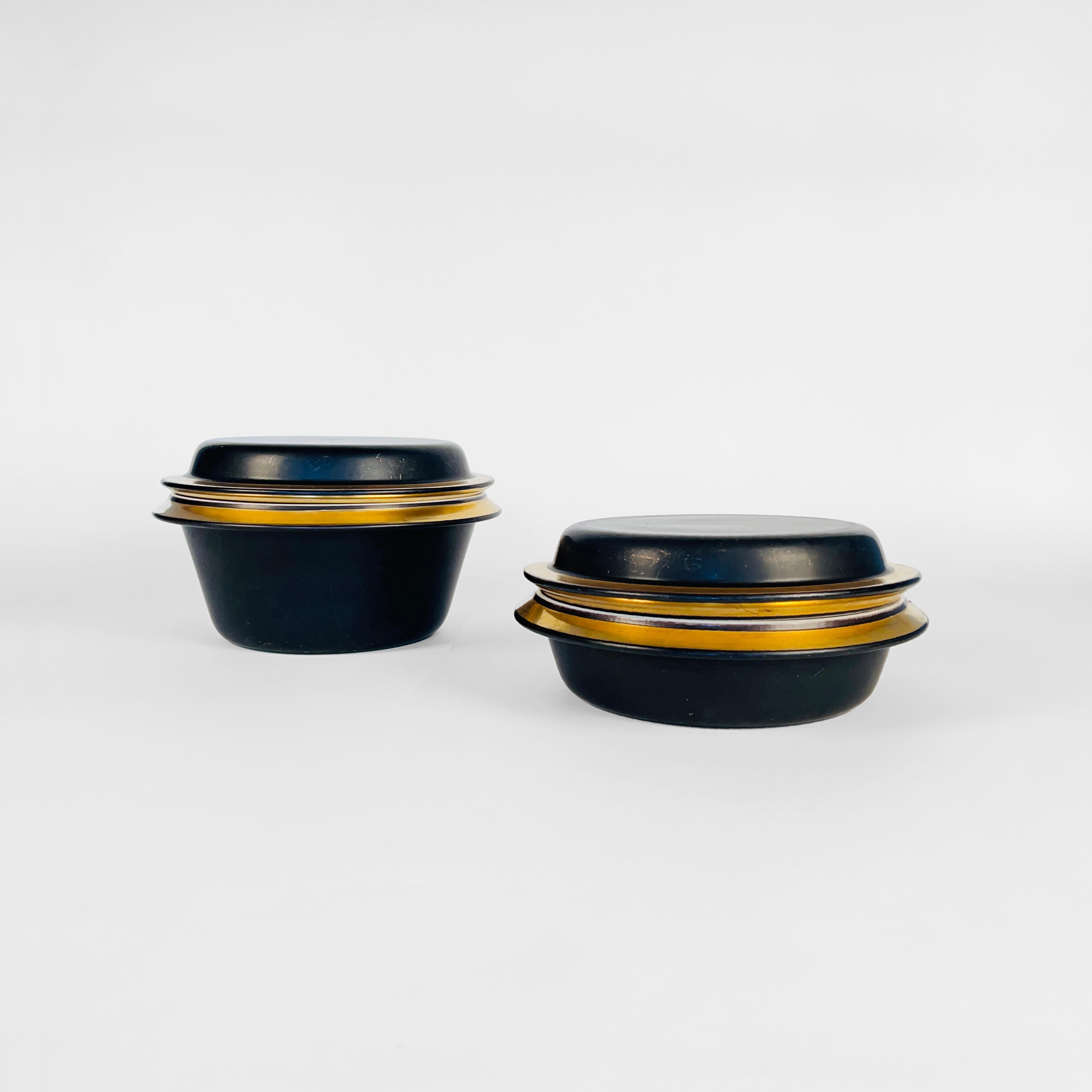 Pair of bowls designed by Ingvar Olsen for Royal Copenhagen Aluminia Faience in 1959.
The exterior is finished in black with a gold rim, and the interior in glossy milky white.
DIMENSIONS
TALL
Height 5.5 IN / 13.97 CM
Diam 9 IN / 22.86 CM
LOW
Height