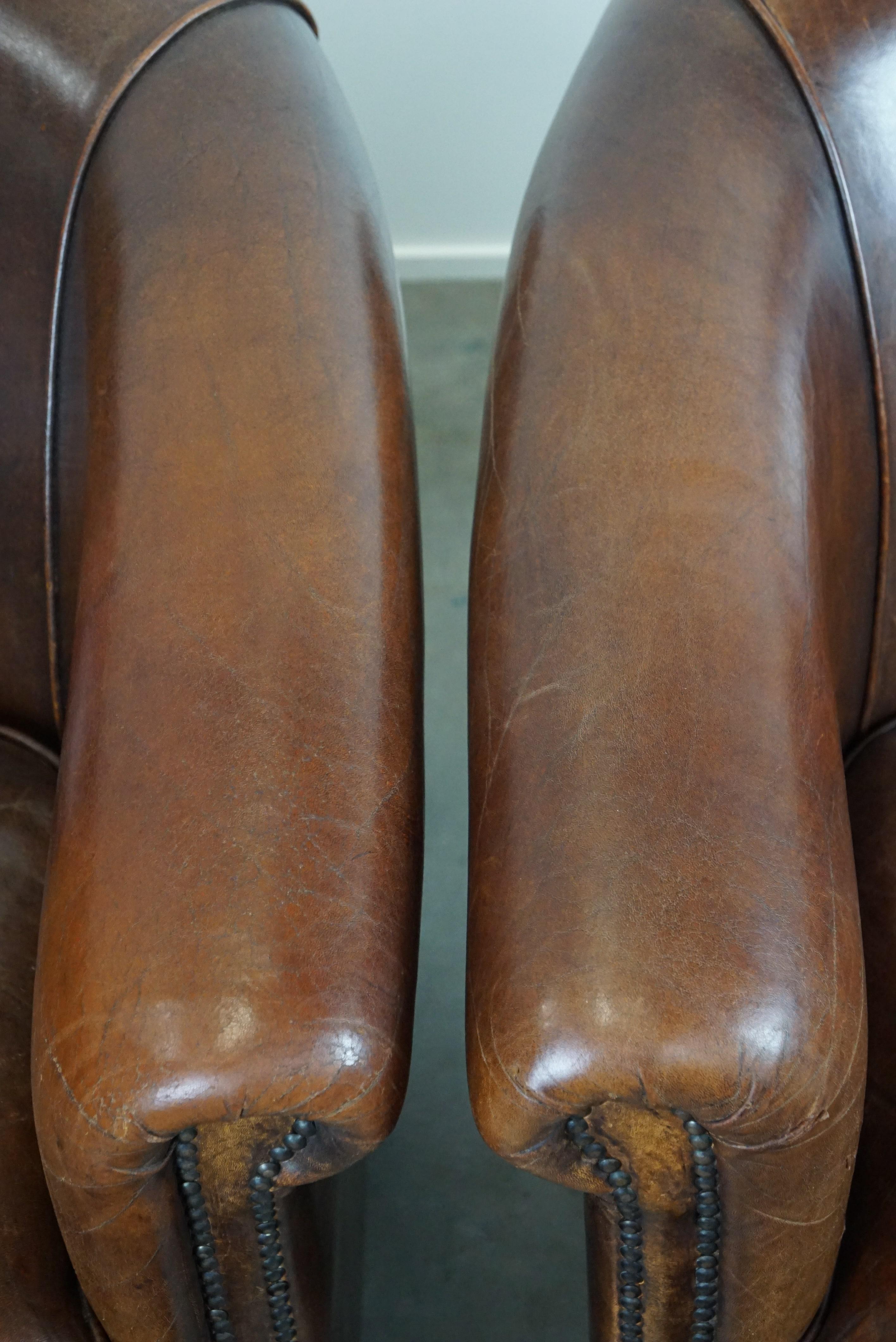 Set of two rugged sheep leather club armchairs with a beautifully worn look For Sale 2