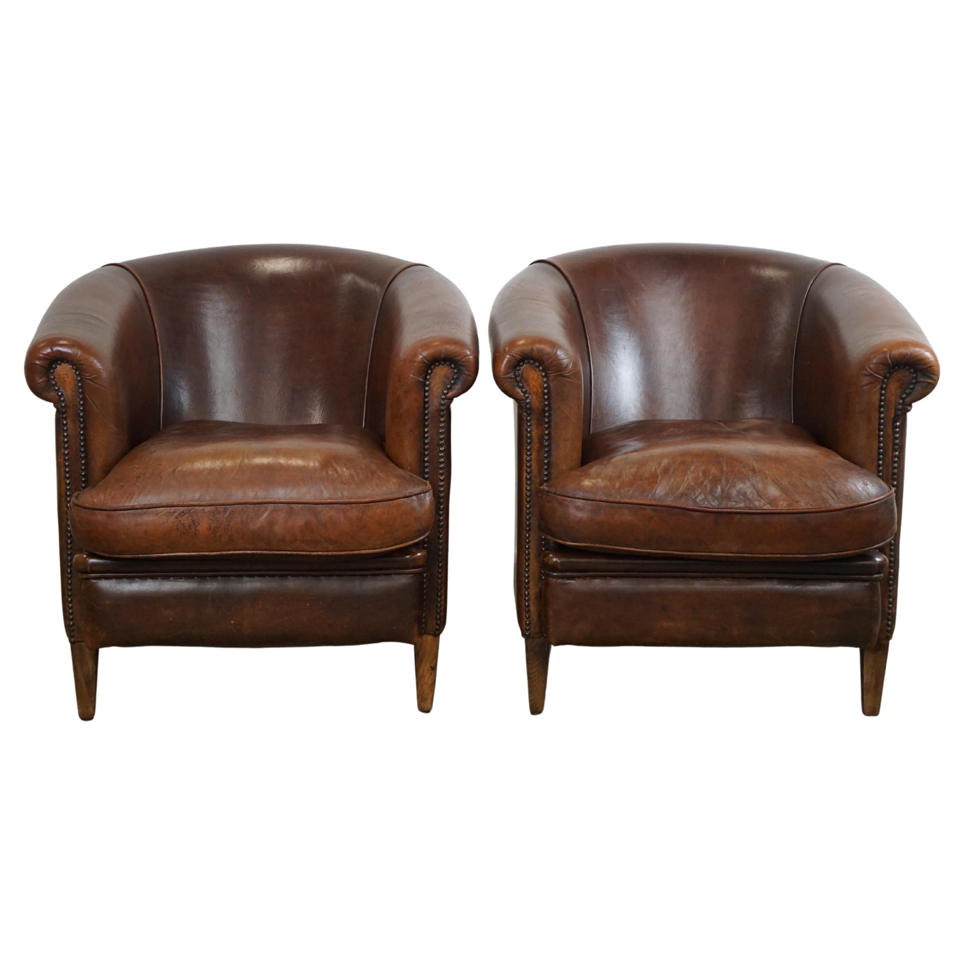 Set of two rugged sheep leather club armchairs with a beautifully worn look For Sale