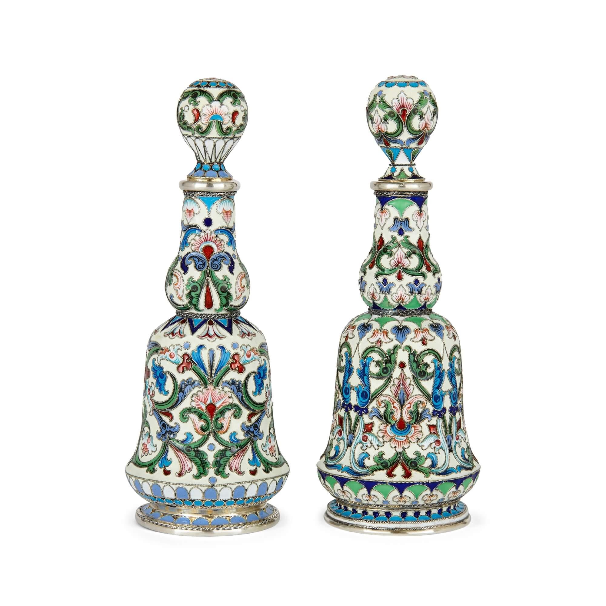 Set of two Russian silver gilt and  cloisonné enamel scent bottles
Russian, 20th Century
Height 13.5cm, diameter 5cm

An embodiment of artistry and precision, this pair of scent bottles radiates the richness and refined craftsmanship of Russia's