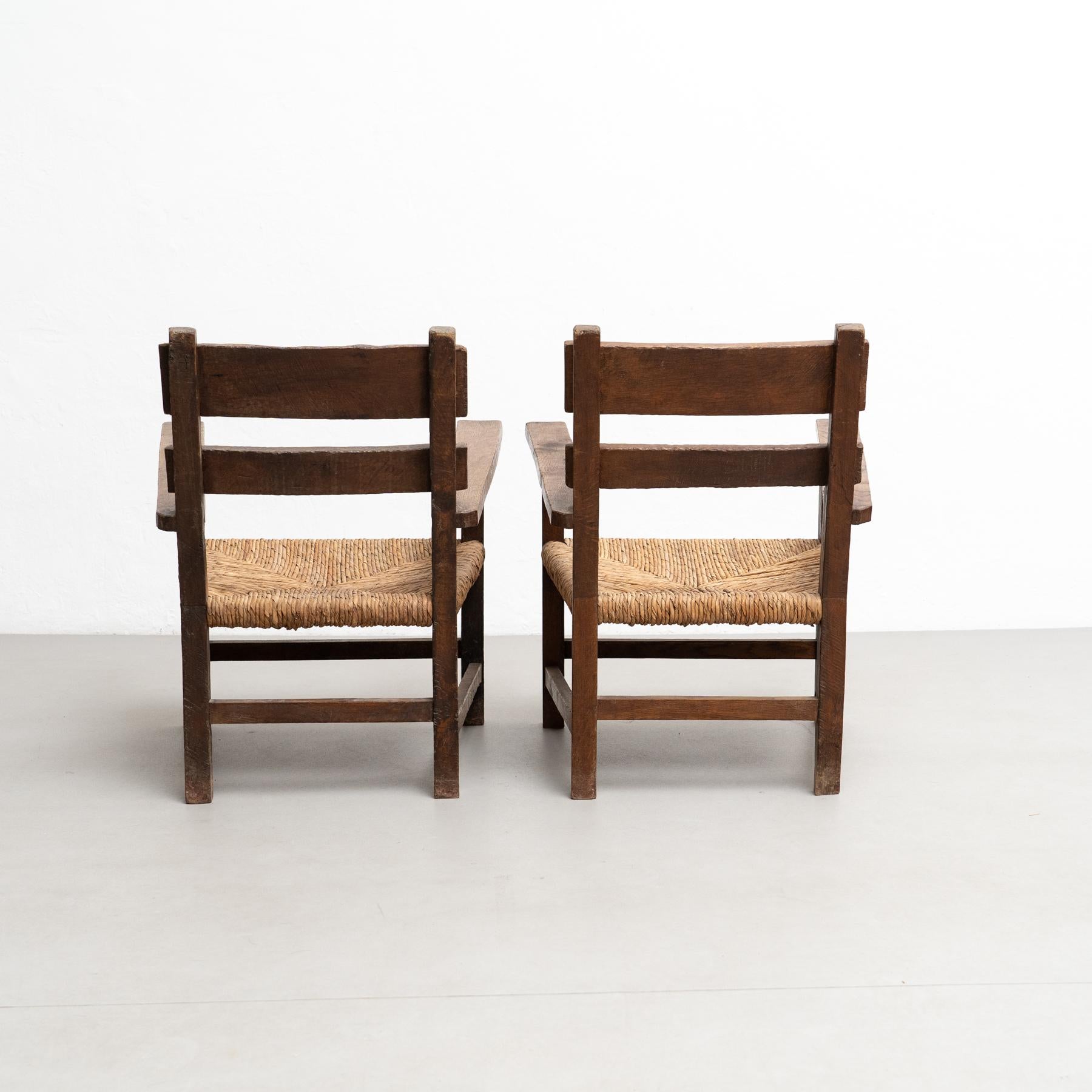 Mid-20th Century Set of Two Rustic Early 20th Century Armchairs in Solid Wood and Rattan For Sale