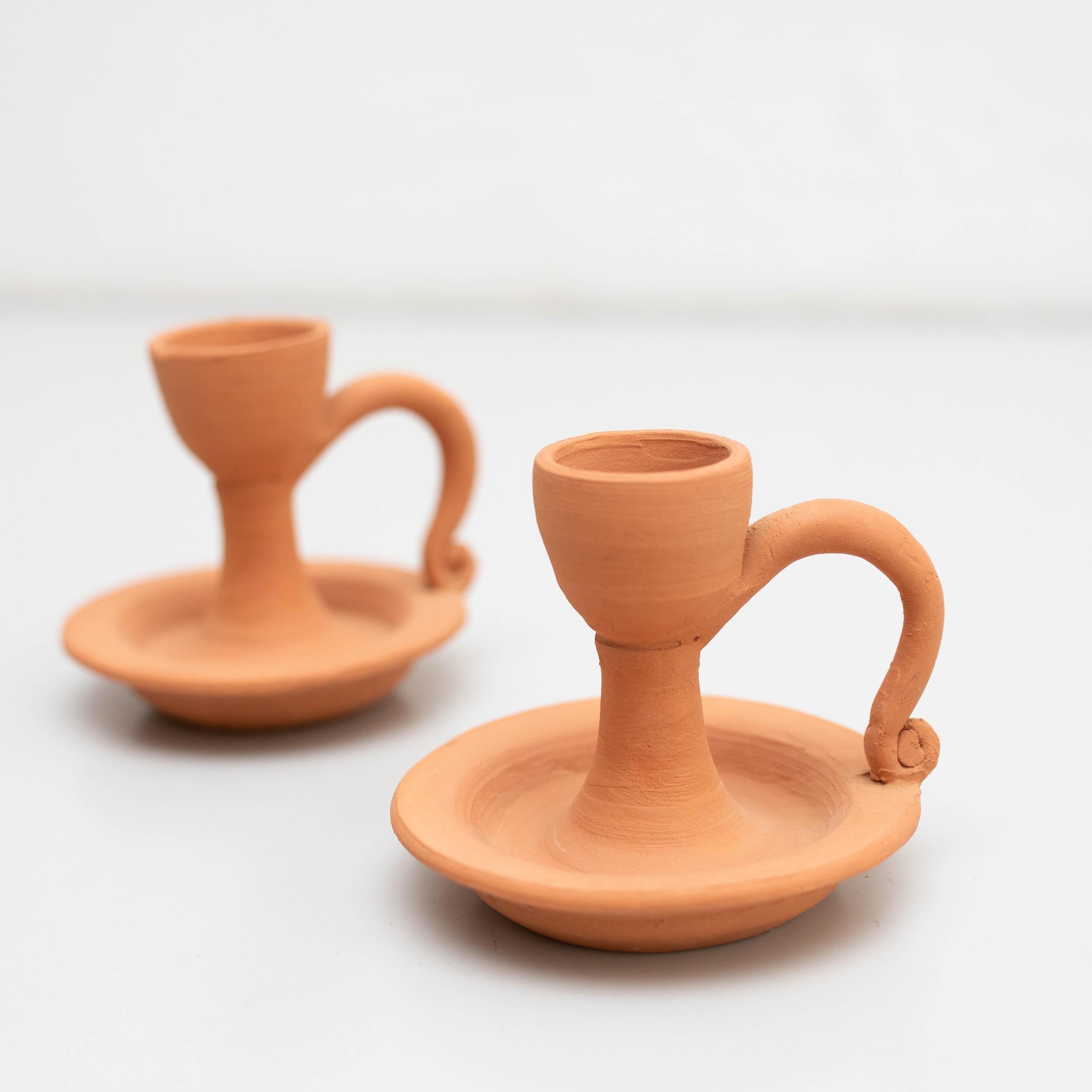 Set of Two Rustic Earthenware Candle Holders, Spain, circa 1960 - Original Condition

Illuminate your home with the warm charm of this beautiful set of two rustic earthenware candle holders, crafted in Spain around 1960 by an unknown manufacturer.