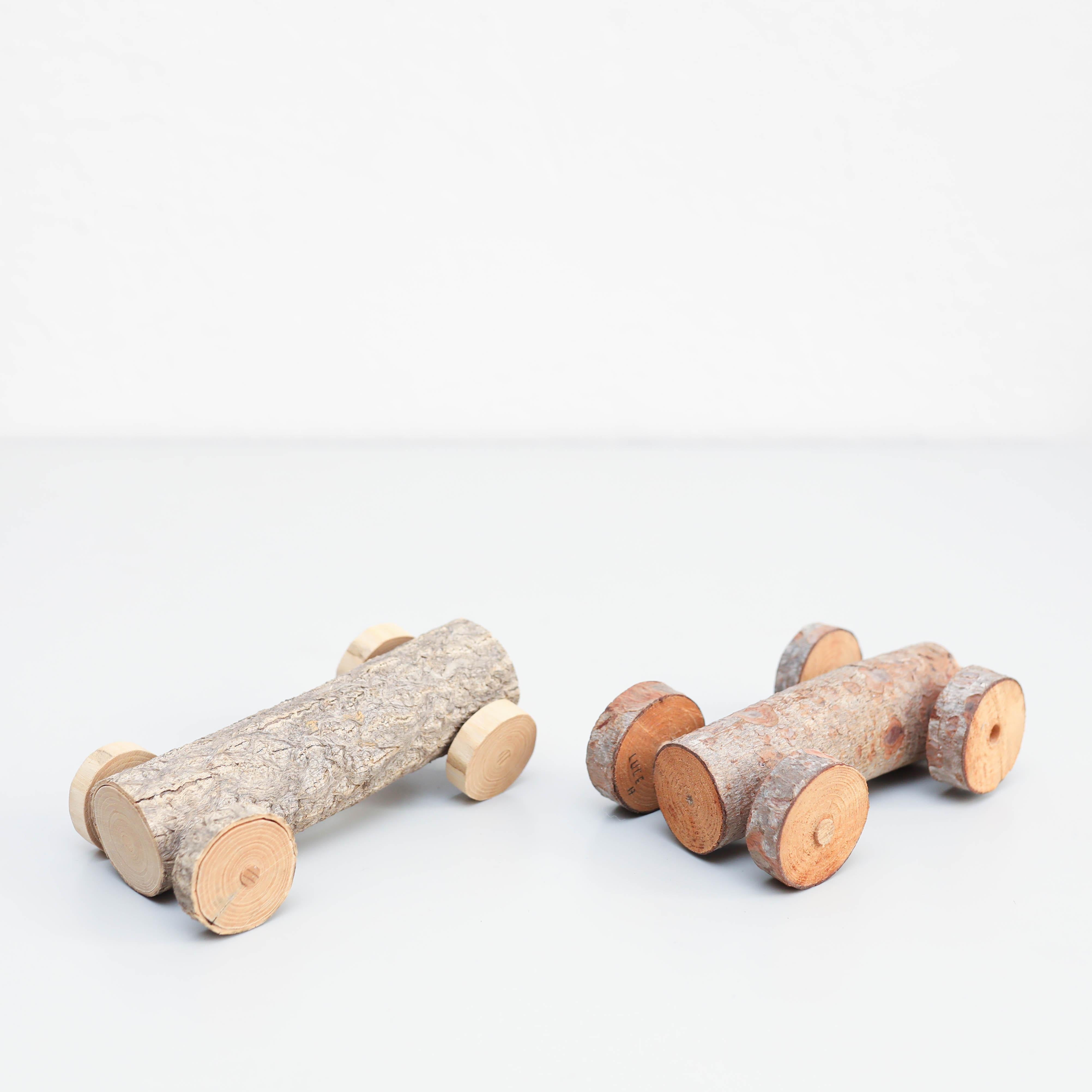 Set of two rustic handmade car toys.
circa 1970.

In original condition, with minor wear consistent with age and use, preserving a beautiful patina.

Materials:
Wood.

Dimensions (each one):
D 9.5 cm x W 18 cm x H 8 cm.