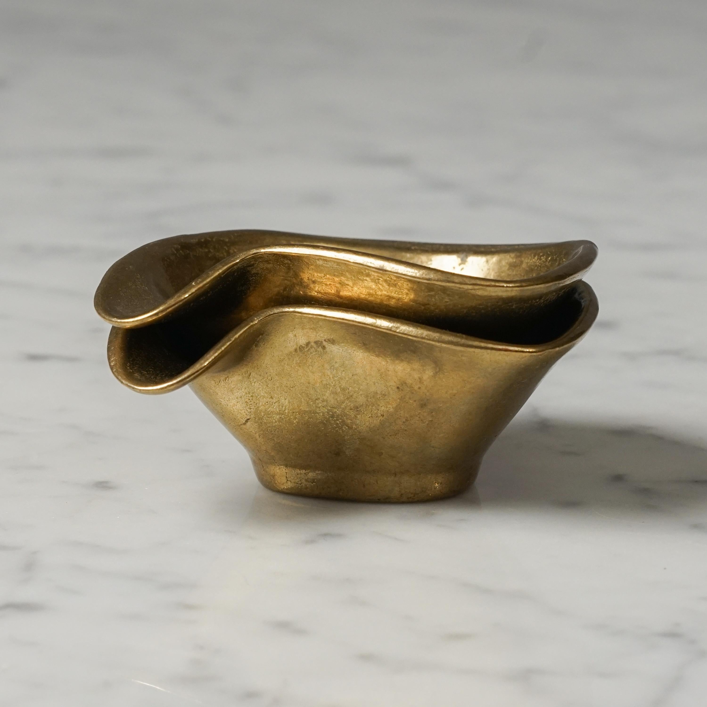 Set of two Scandinavian Modern nesting brass ashtrays from the mid 1900s. Solid brass. Stamped on the bottoms. Good vintage condition, minor wear consistent with age and use.