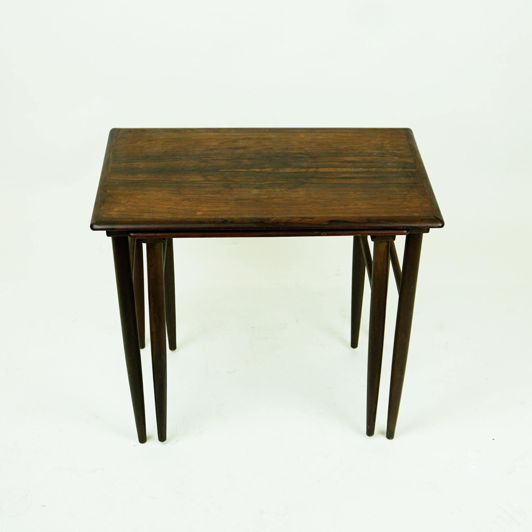 This set of two rosewood nesting tables was designed by Poul Hundevad for Fabian Denmark in the 1960s.
The tables are made from finest rosewood and are in very good slightly restored condition. Beautiful tapered legs the small table slides into the