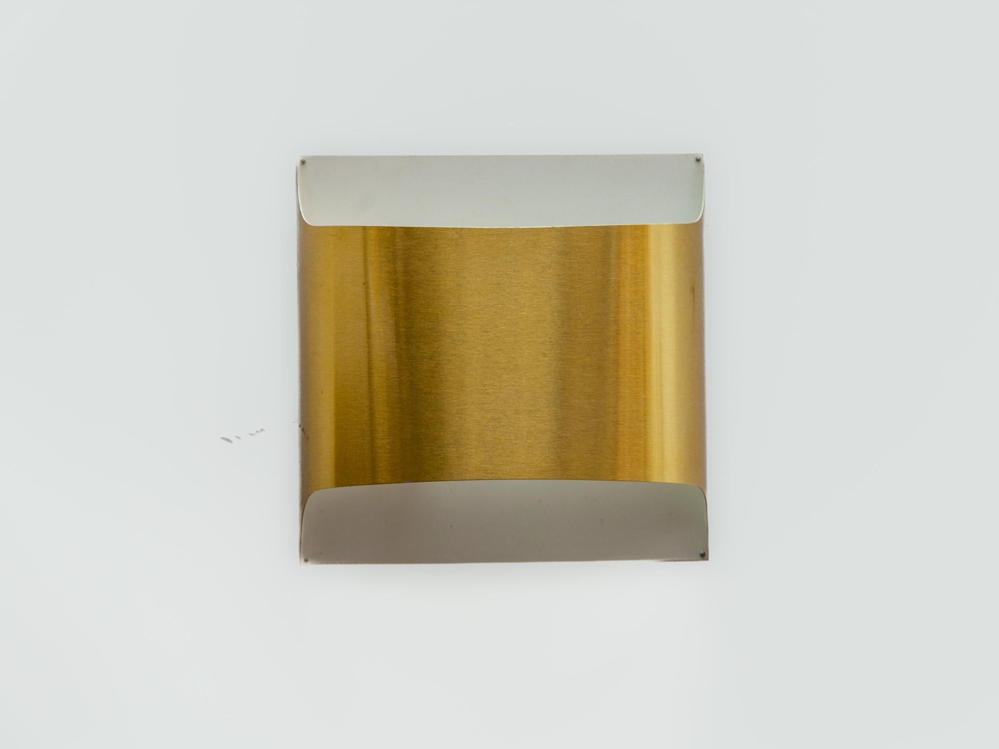 Architectural set of two 1970s minimalist modern design, metal gold wall lamps designed by Rolf Krüger and Dieter Witte for manufacture STAFF Leuchten, Germany.
The wall lights designed to direct an equal amount of light up and down, will help to
