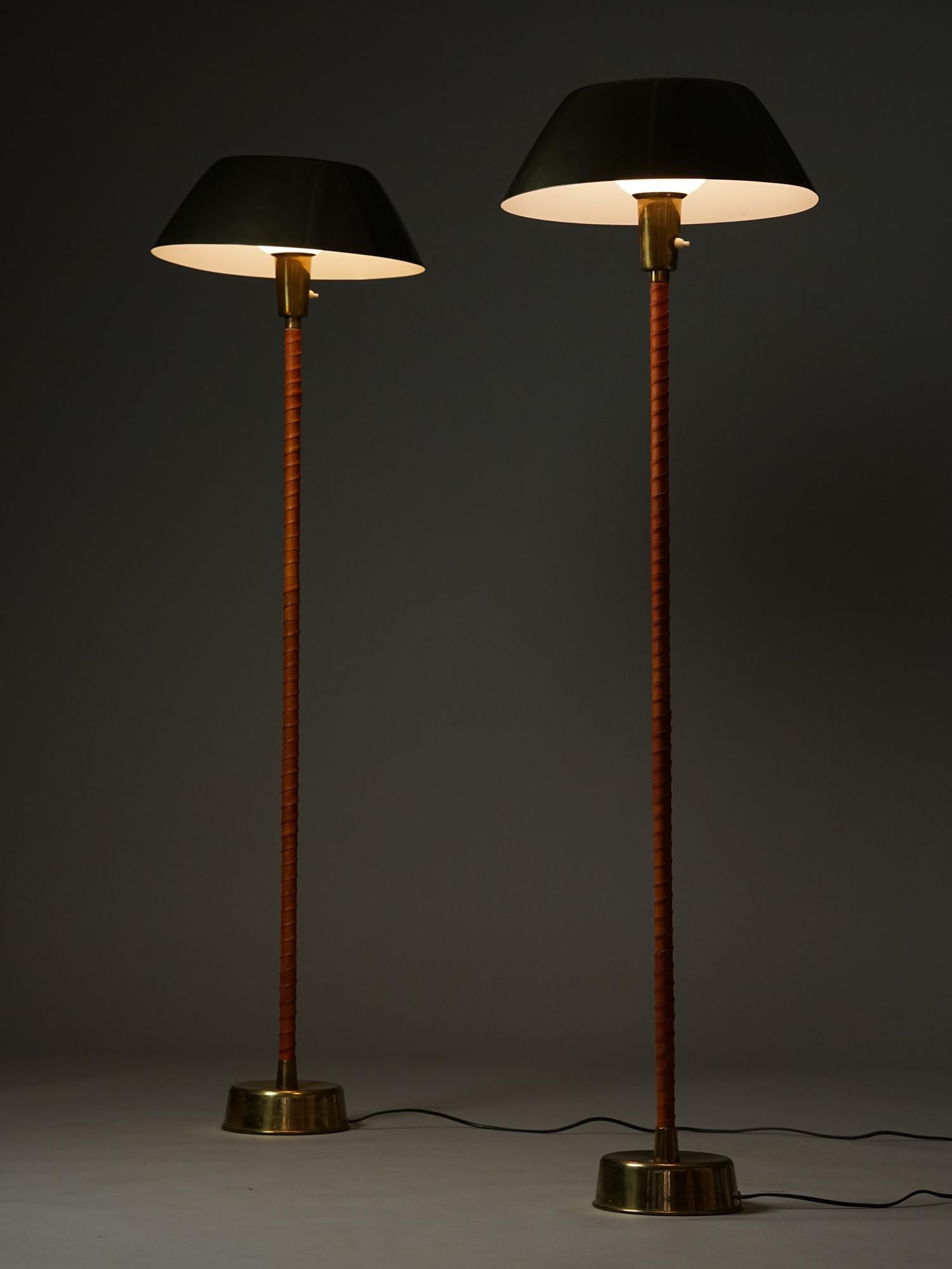 Set of two Senator floor lamps by Lisa Johansson-Pape for Orno from the 1950s. Leather wrapped stem, brass details, metal lampshade. Orno stamp on both. Good vintage condition, minor wear consistent with age and use. Iconic design. The floor lamps