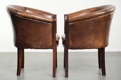 Set of two sheepskin armchairs / tub chairs with a beautiful patina