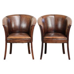 Set of two sheepskin armchairs / tub chairs with a beautiful patina