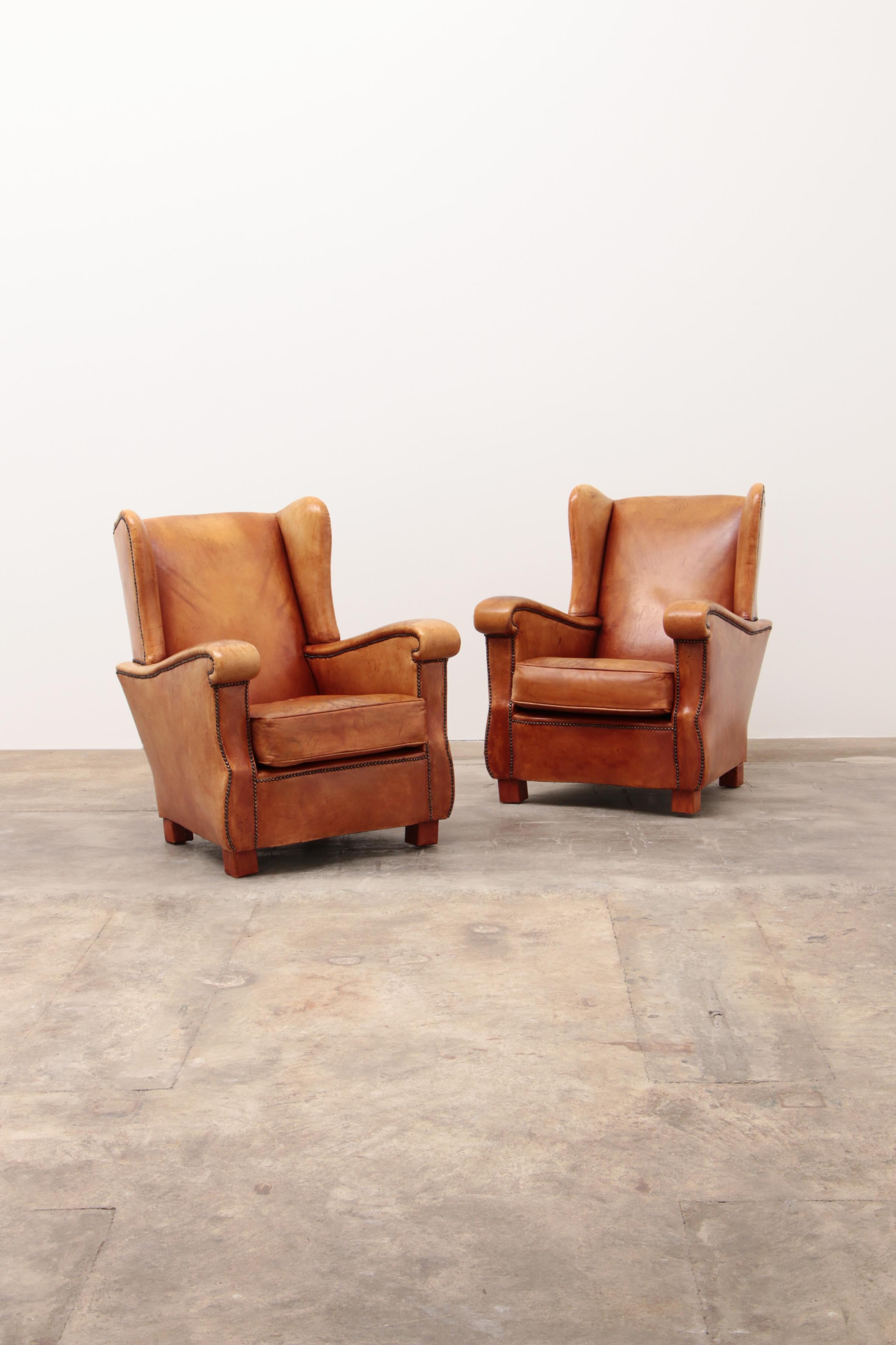 Set of beautiful sheep leather ear armchairs in excellent condition, finished with decorative furniture nails, a beautiful model.

The chairs still have a great seat and can last for years.

Sustainable: Environmentally conscious By