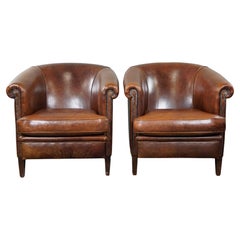 Set of two sheepskin leather club armchairs with a beautiful patina