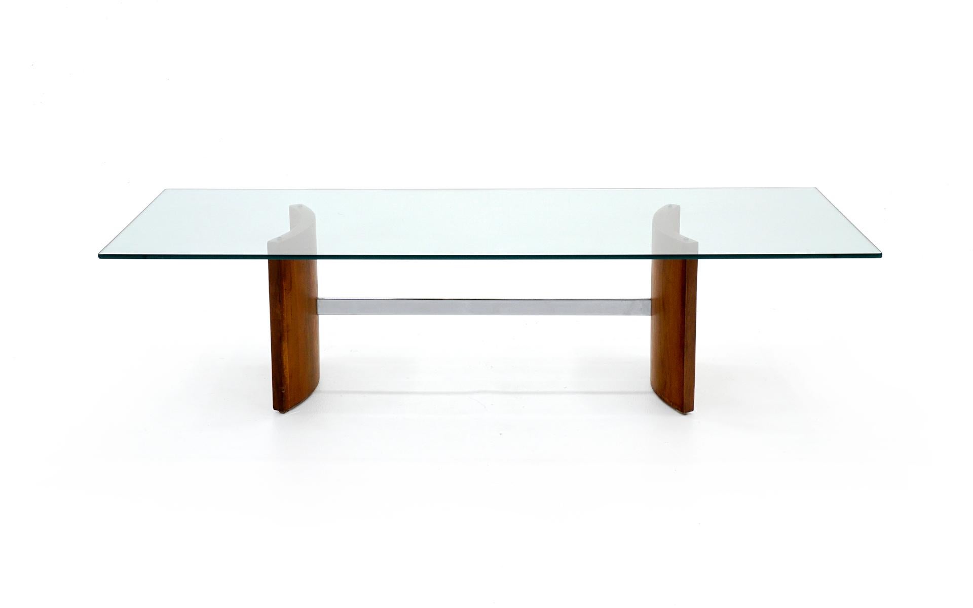 Two end tables and one coffee table. Curved walnut bases with chrome connecting bar with original glass tops.

Measures: Coffee table
14.75 in. H x 25 in. D x 60 in. W
Side tables
19.5 in H x 22 in. D x 32 in. W.