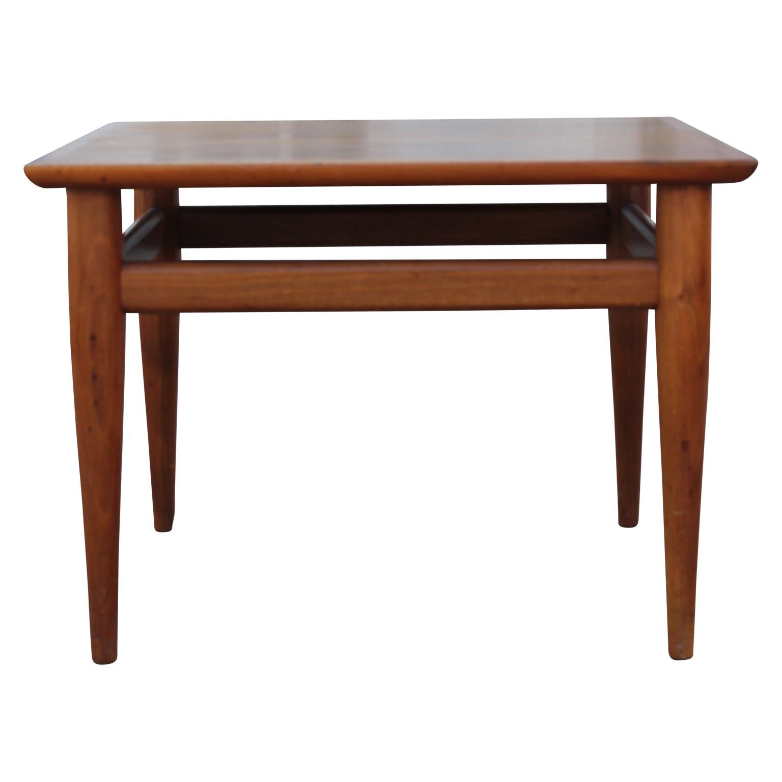 Sleek midcentury style side table. The clean lines and polished wood make it very beautiful to use as an end table.