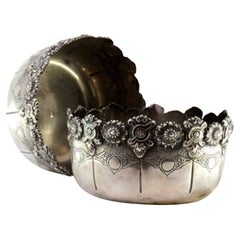 Set of two silver washbasins with exposed, cut edges and engraved bodies