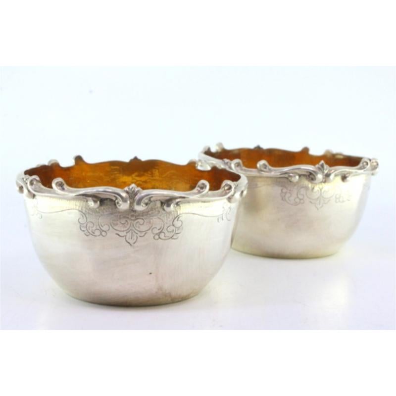 Description: Set of two silver washbasins with raised edges and gilded interiors. Metal: Silver. Origin: Portuguese. Mark: Standing eagle. Weight: 259.74 grams. Dimensions: 10cm x 5cm. Content: 916/1000. Assay Mark: Yes, between 1938 and 1984.