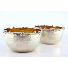 Set of two silver washbasins with raised edges and gold interiors