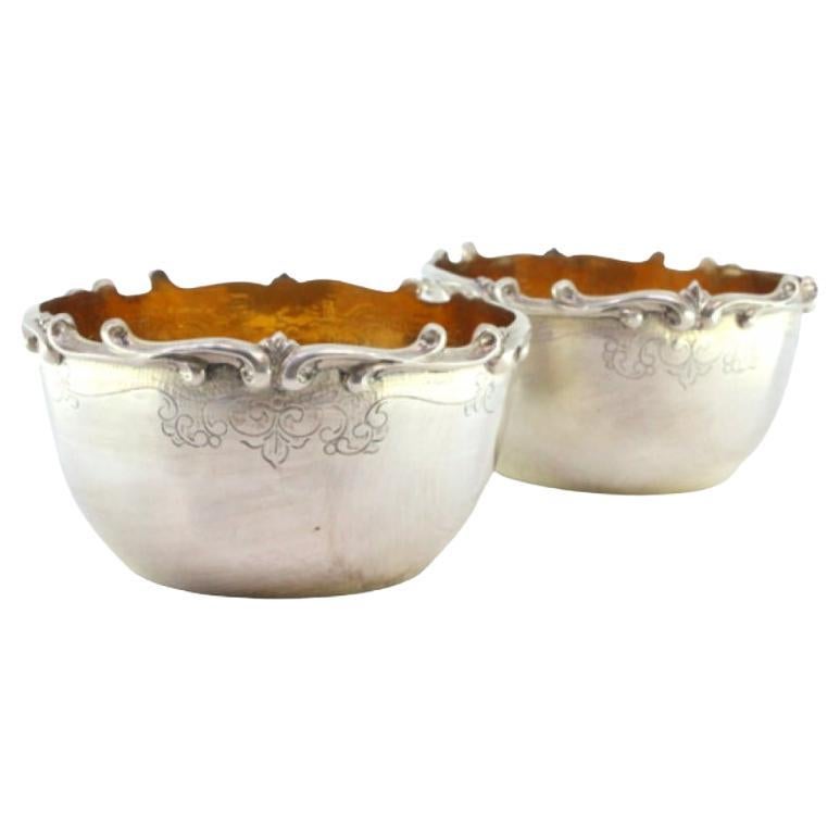 Set of two silver washbasins with raised edges and gold interiors