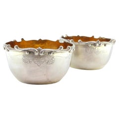 Set of two silver washbasins with raised edges and gold interiors