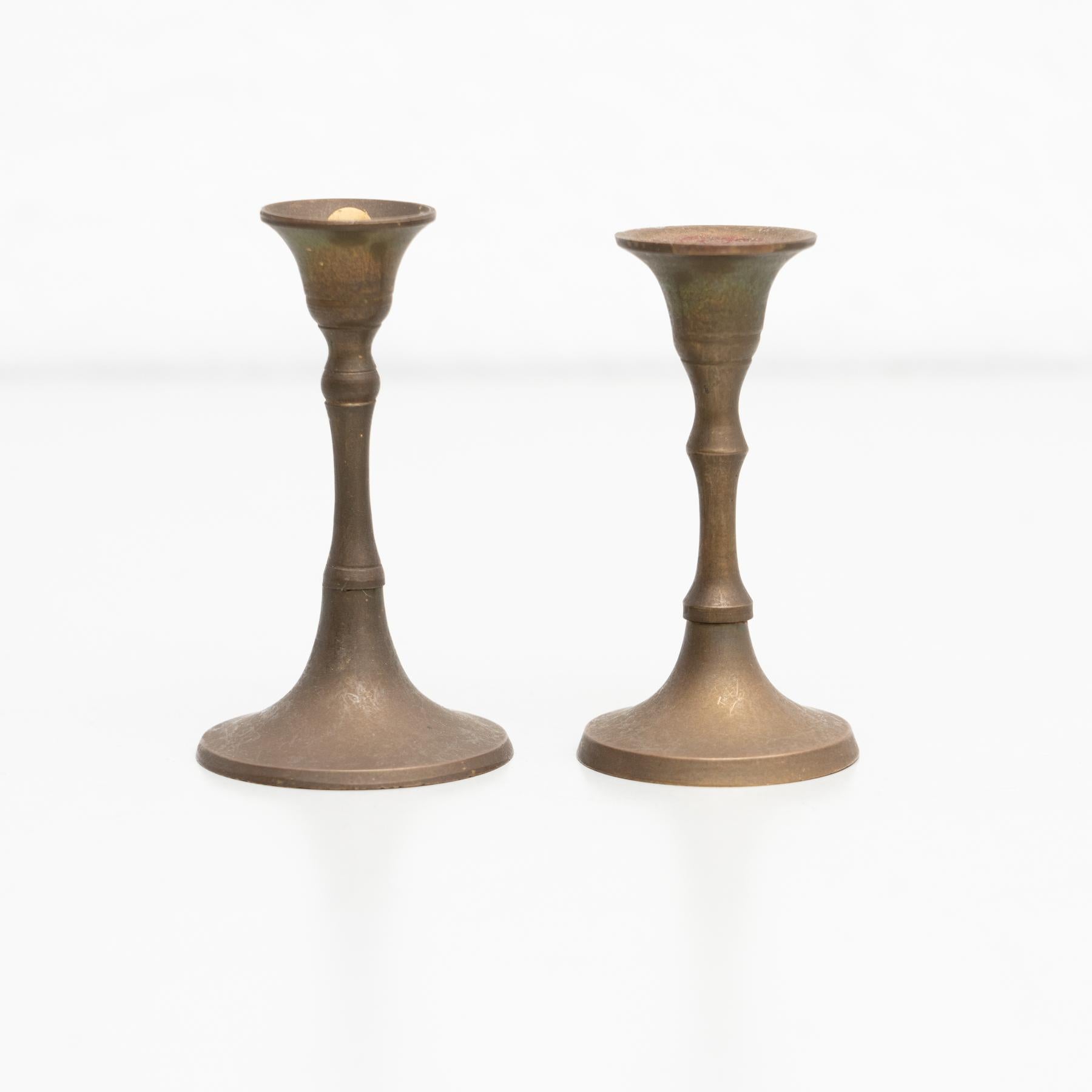 Set of two rustic brass candle holders, circa 1950
By unknown manufacturer, made in Spain

In original condition, with minor wear consistent with age and use, preserving a beautiful patina.
  
Material:
Brass.

