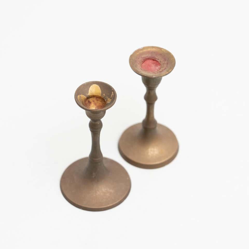 Set of two rustic brass candle holders, circa 1950
By unknown manufacturer, made in Spain

In original condition, with minor wear consistent with age and use, preserving a beautiful patina.
  
Material:
Brass.

