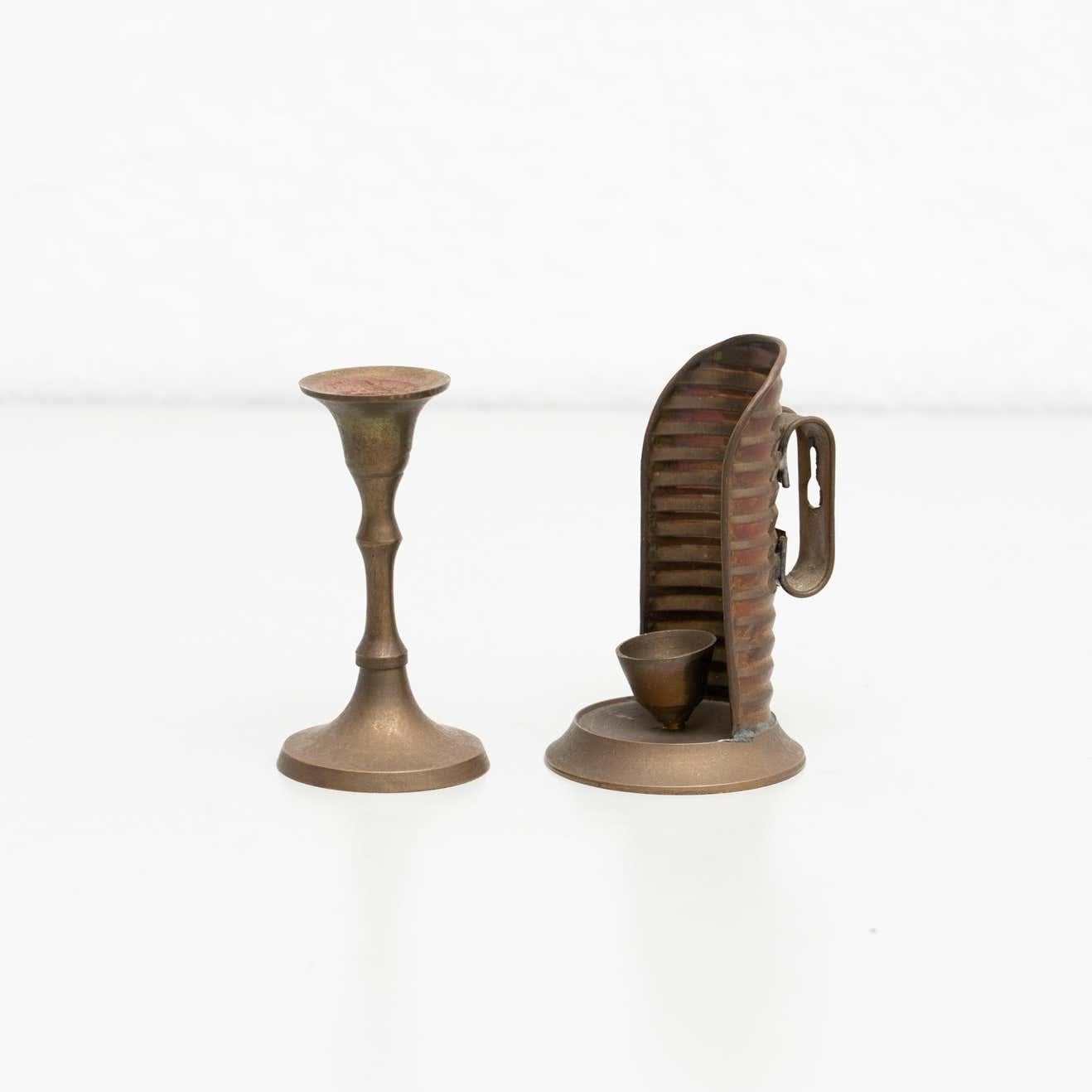 Set of two rustic brass candleholders, circa 1950
By unknown manufacturer, made in Spain

In original condition, with minor wear consistent with age and use, preserving a beautiful patina.
  
Material:
Brass.

 