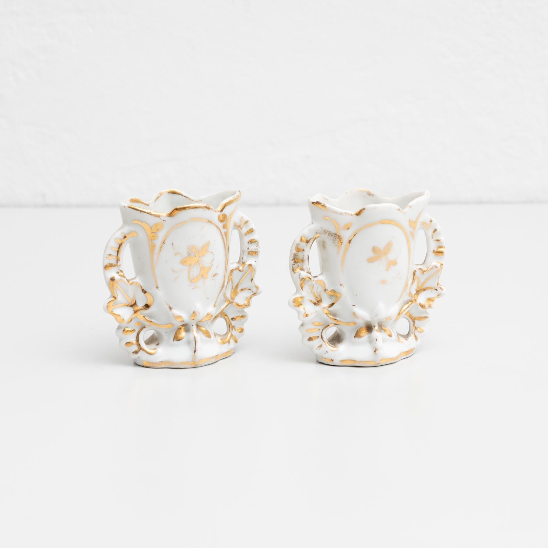 Pair of Isabelline hand-painted porcelain vases in the Serves style. Beautifully decorated with a guilted design on the front side.     Made by unknown manufacturer in Spain, circa 19th Century.    In original condition, with minor wear consistent