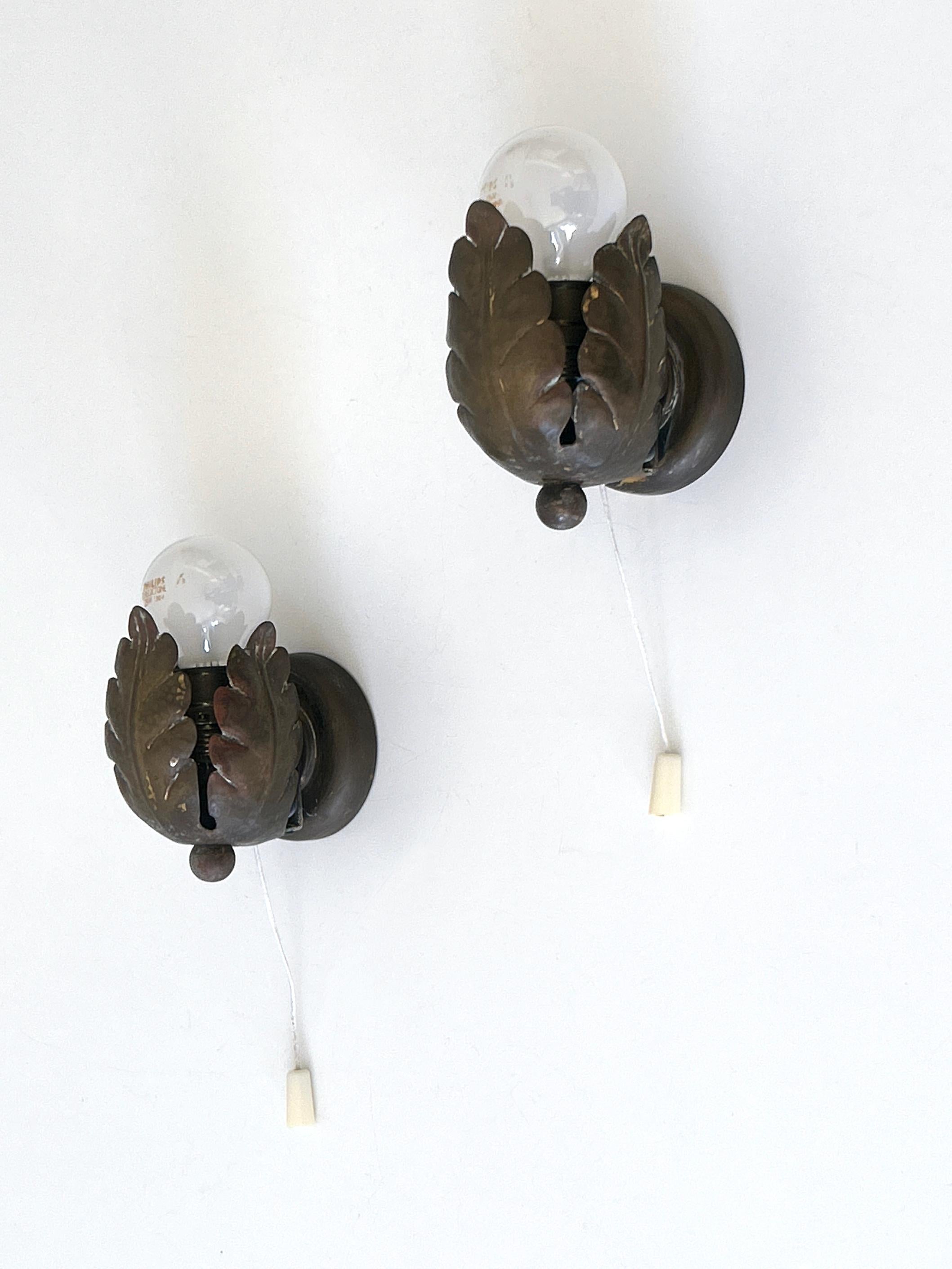 Set of two extremely rare, lovely and highly decorative Mid-Century Modern flower buds sconces or wall fixtures. Designed and manufactured in Germany, 1950s.

Executed in brass, each fixture has 1 x E14 / E12 Edison screw fit bulb socket, is wired