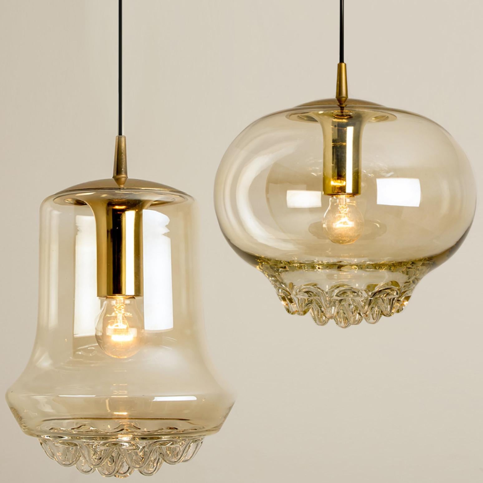 Set of two smoked golden/brown pendant lights, 1960s by Peill and Putzler in Germany, Europe. A unique shape and a wonderful light effect due to lovely glass elements. High quality pieces. Illuminates beautiful. True craftsmanship of the 20th