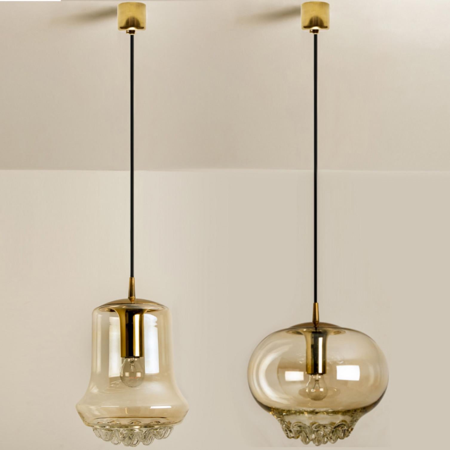 Set of two smoked golden/brown pendant lights, 1960s by Peill and Putzler in Germany, Europe. A unique shape and a wonderful light effect due to lovely glass elements. High quality pieces. Illuminates beautiful. True craftsmanship of the 20th