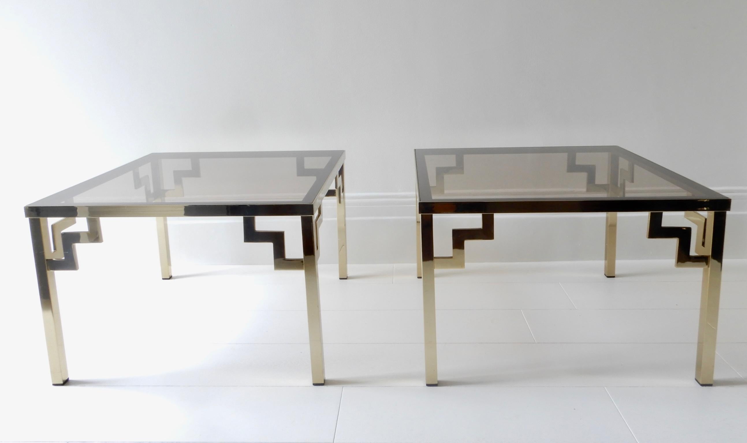 Set of two smoked glass and brass coffee/side tables, 1970s.