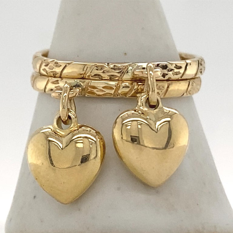 Eytan cast these bands from his wife's grandmother's wedding ring, so they're already chock full of love, but just to drive the point home, he dangled a couple of sweet little hearts from each ring.  A great friendship ring, or wear them stacked,