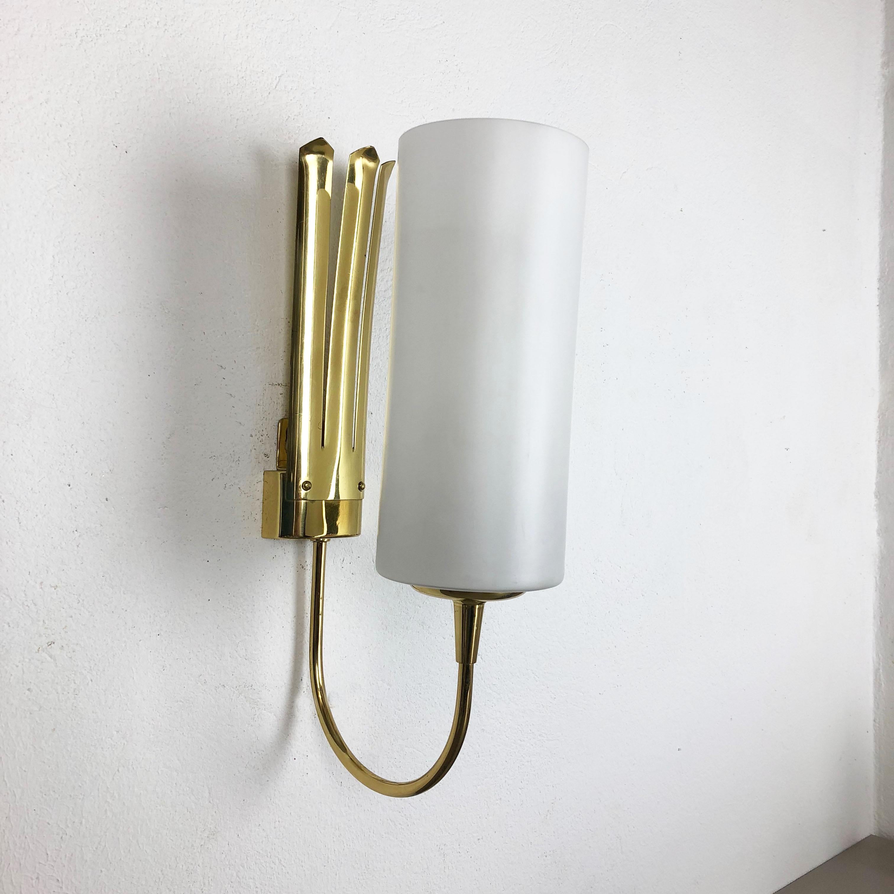 Article:

Set of two

Wall light scones


Origin:

Italy



Age:

1950s



This set of two modernist lights was produced in Italy in the 1950s. It is made from solid brass metal and has a lovely formed white satin tube form shade.
