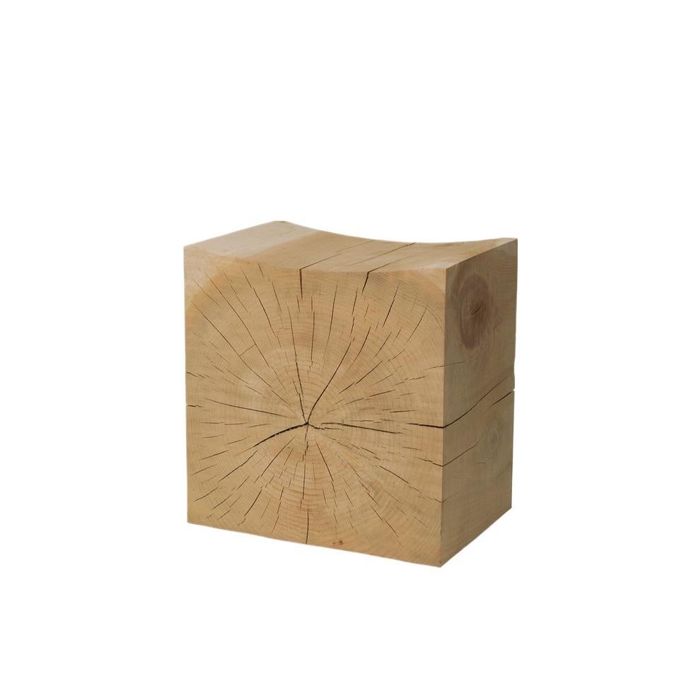 Fashioned from a single block of aromatic cedar, this stool showcases a concave ergonomic seat ensuring comfort. It boasts side grooves for easy handling. Crafted entirely from natural wood, each piece is hand-finished without any additional