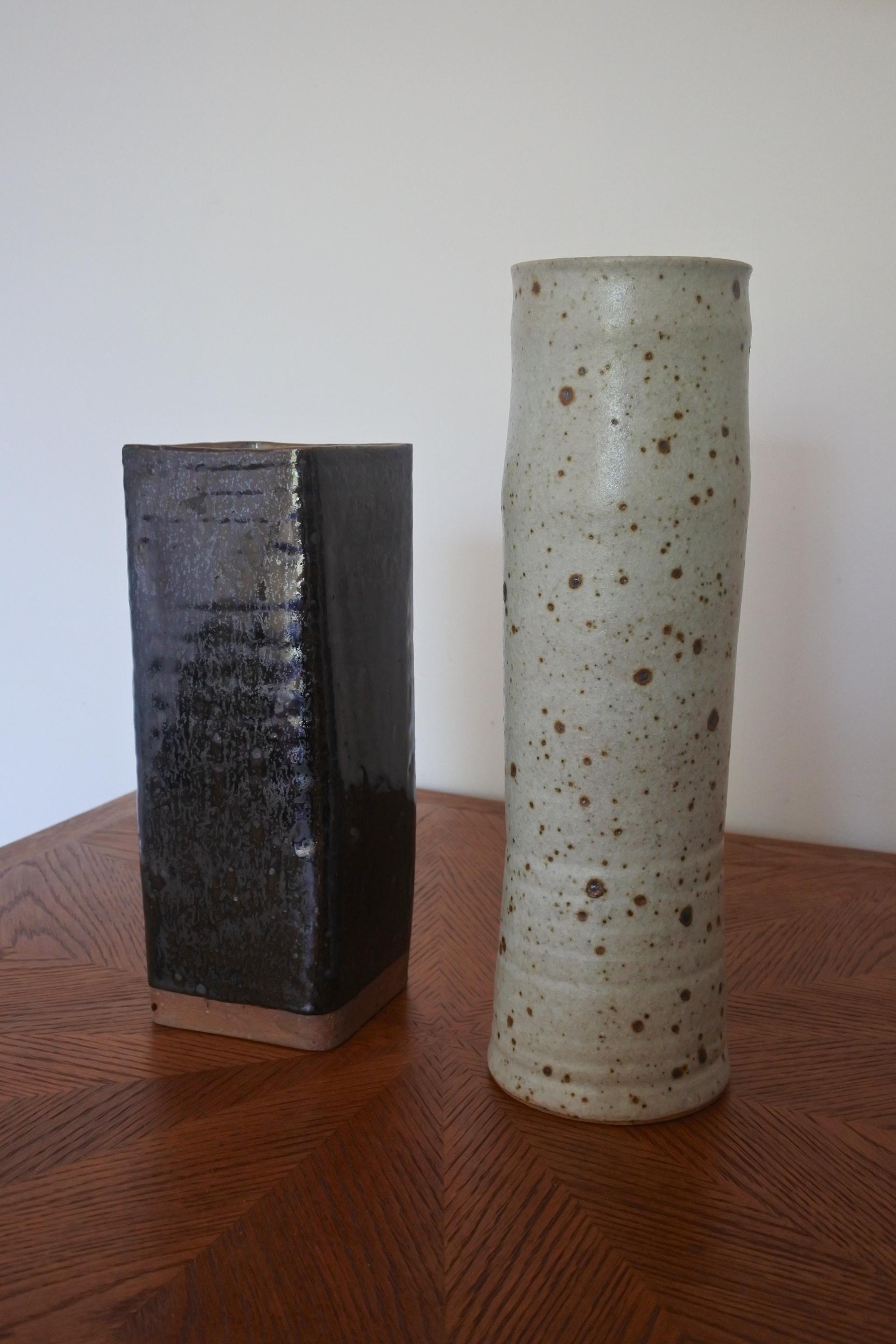 Set of two large Studio Pottery vases.
Glazed earthenware. Rich dark brown crystallised glaze for the square shaped one, thick grey salt glaze for the cylinder shaped one, in the manner of La Borne, France.
Made in France in the 1960s.
Both