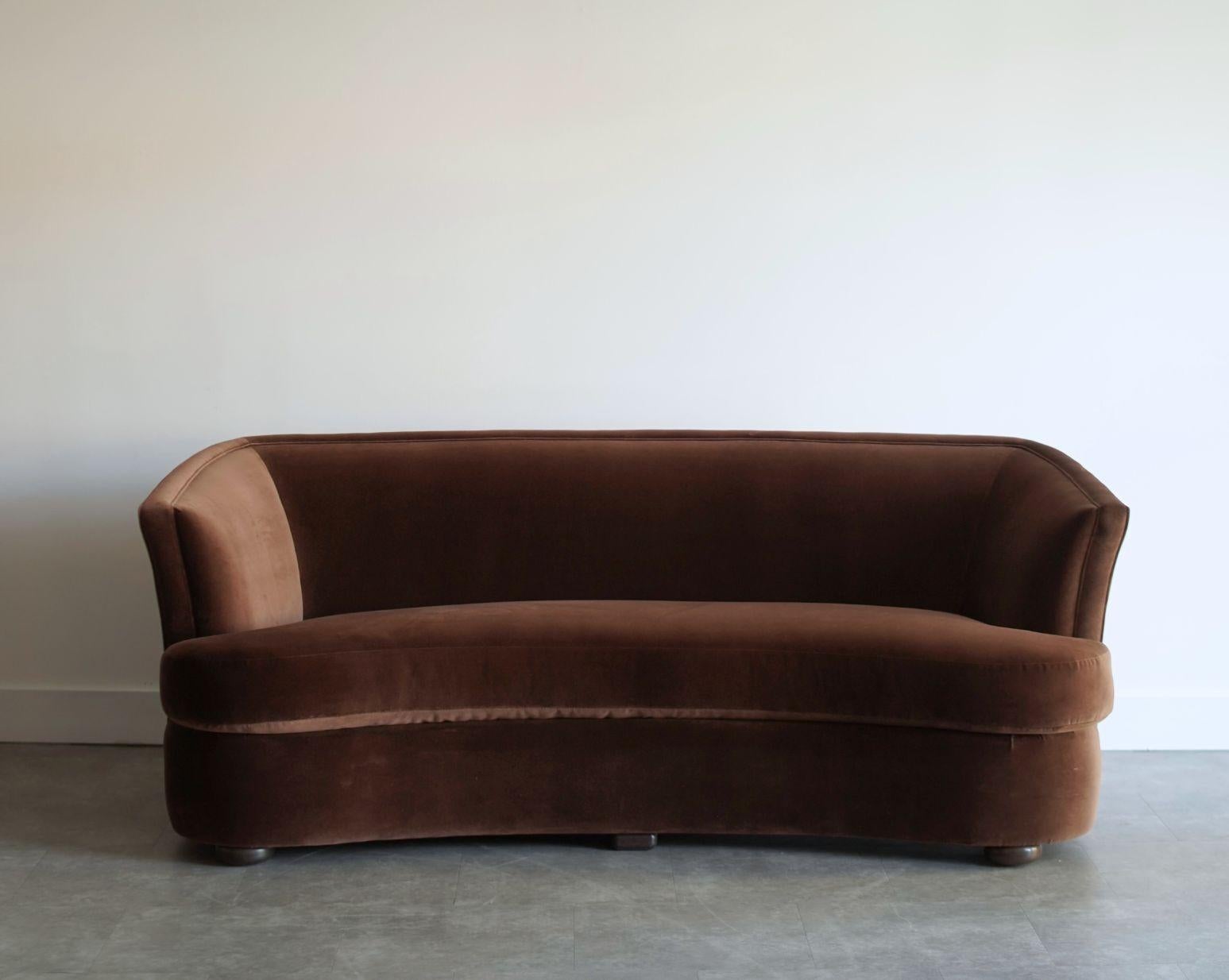 This elegant pair of 1960s Swedish cabinet-maker sofas has been meticulously restored by Stamford Modern, bringing new life to their refined mid-century silhouette. Each sofa features a gently curved frame that offers exceptional comfort and